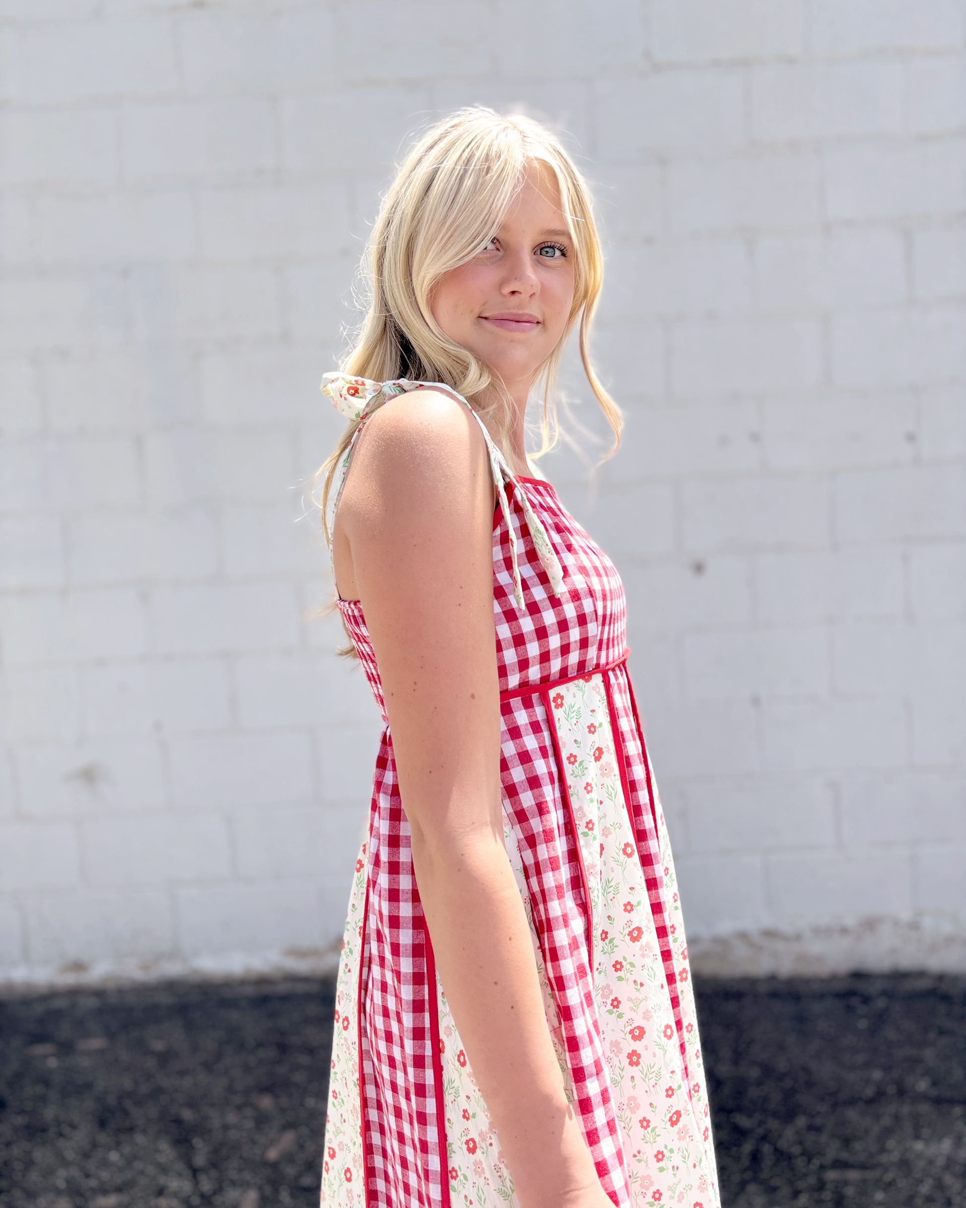 Red gingham dress with red floral print panels on a long dress with bow tie straps