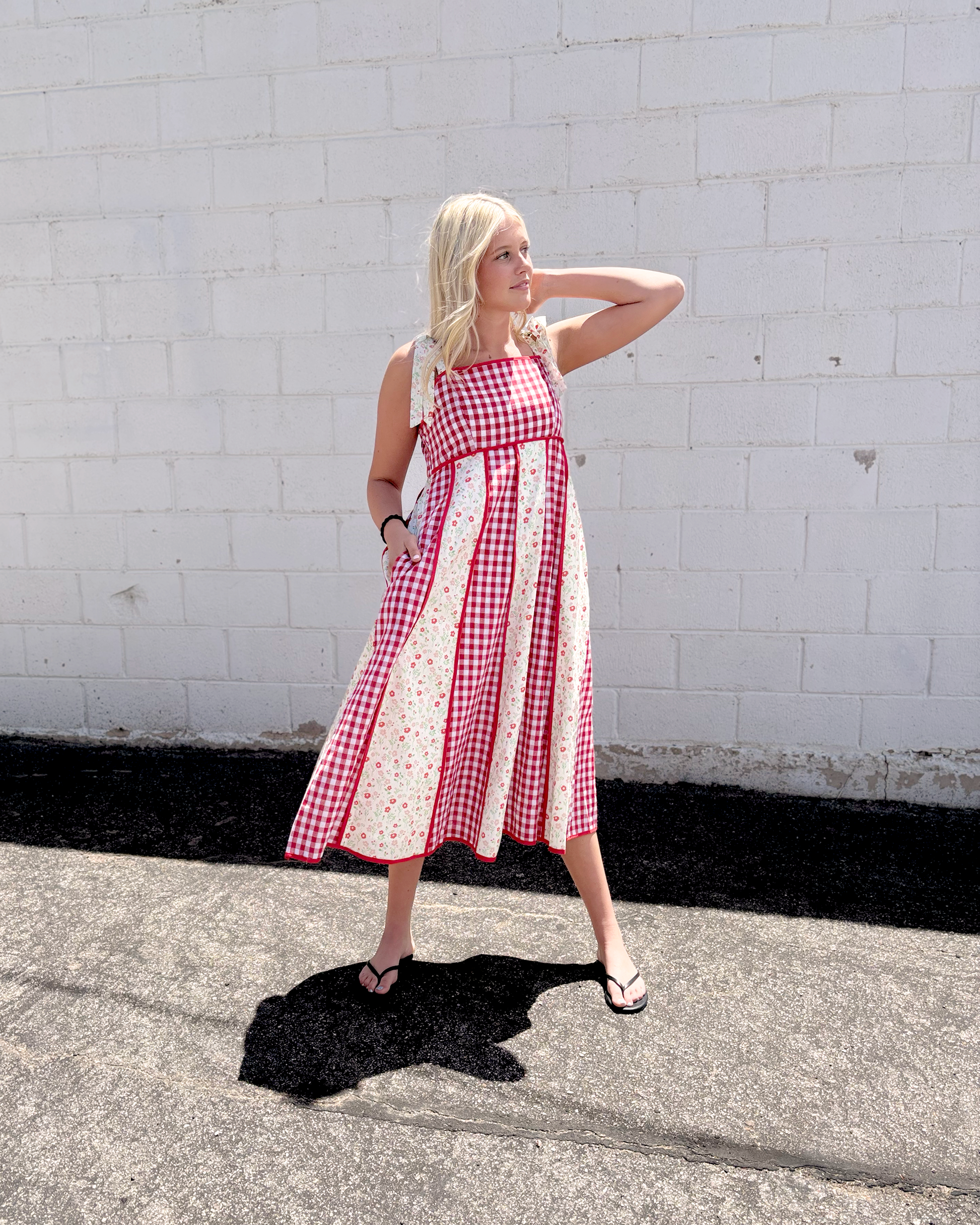 Red gingham dress with red floral print panels on a long dress with bow tie straps