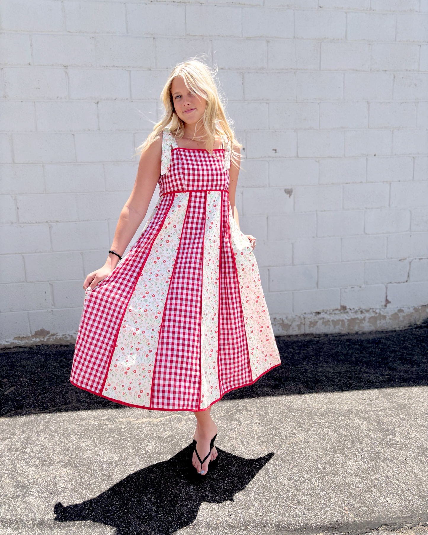 Red gingham dress with red floral print panels on a long dress with bow tie straps