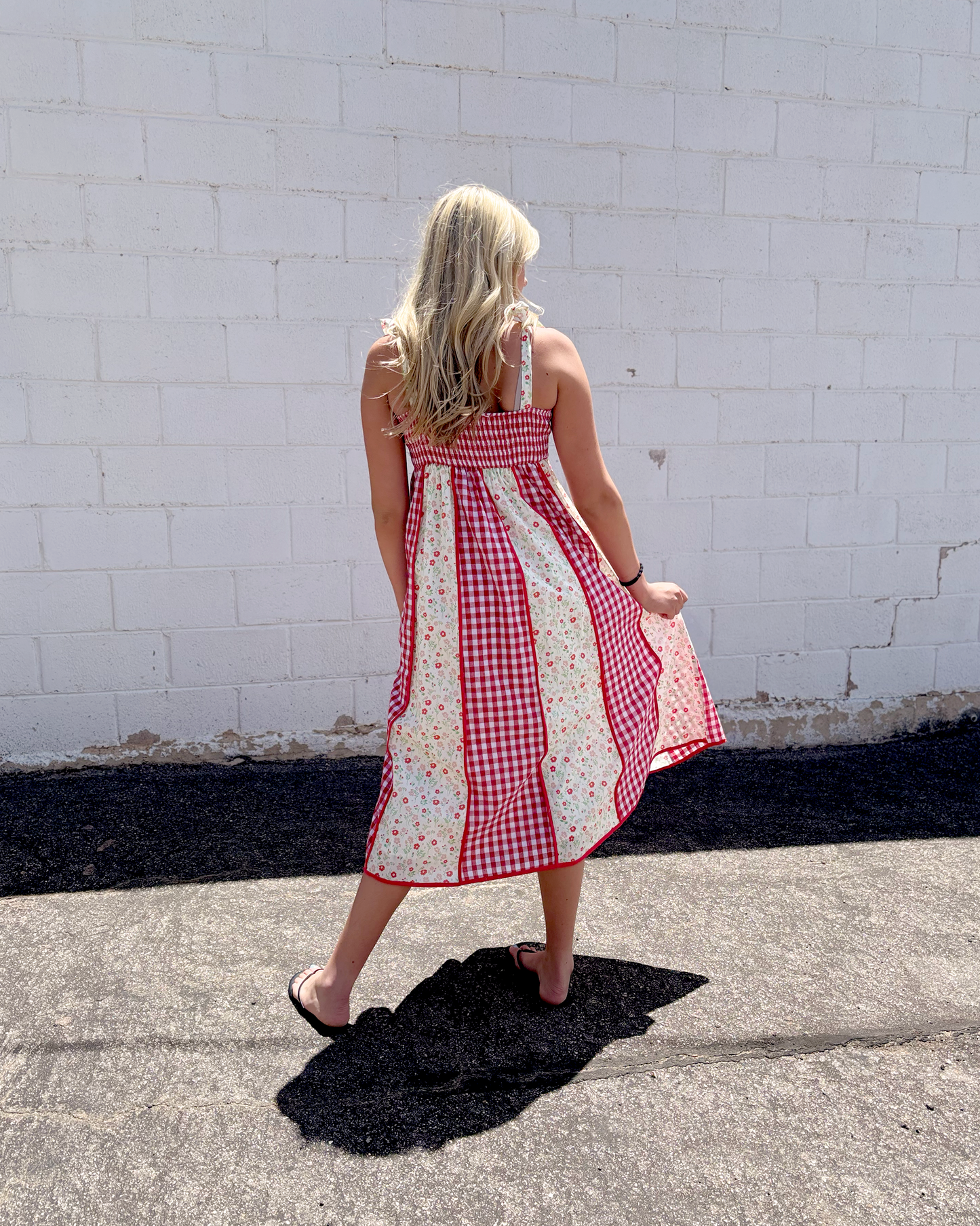 Red gingham dress with red floral print panels on a long dress with bow tie straps