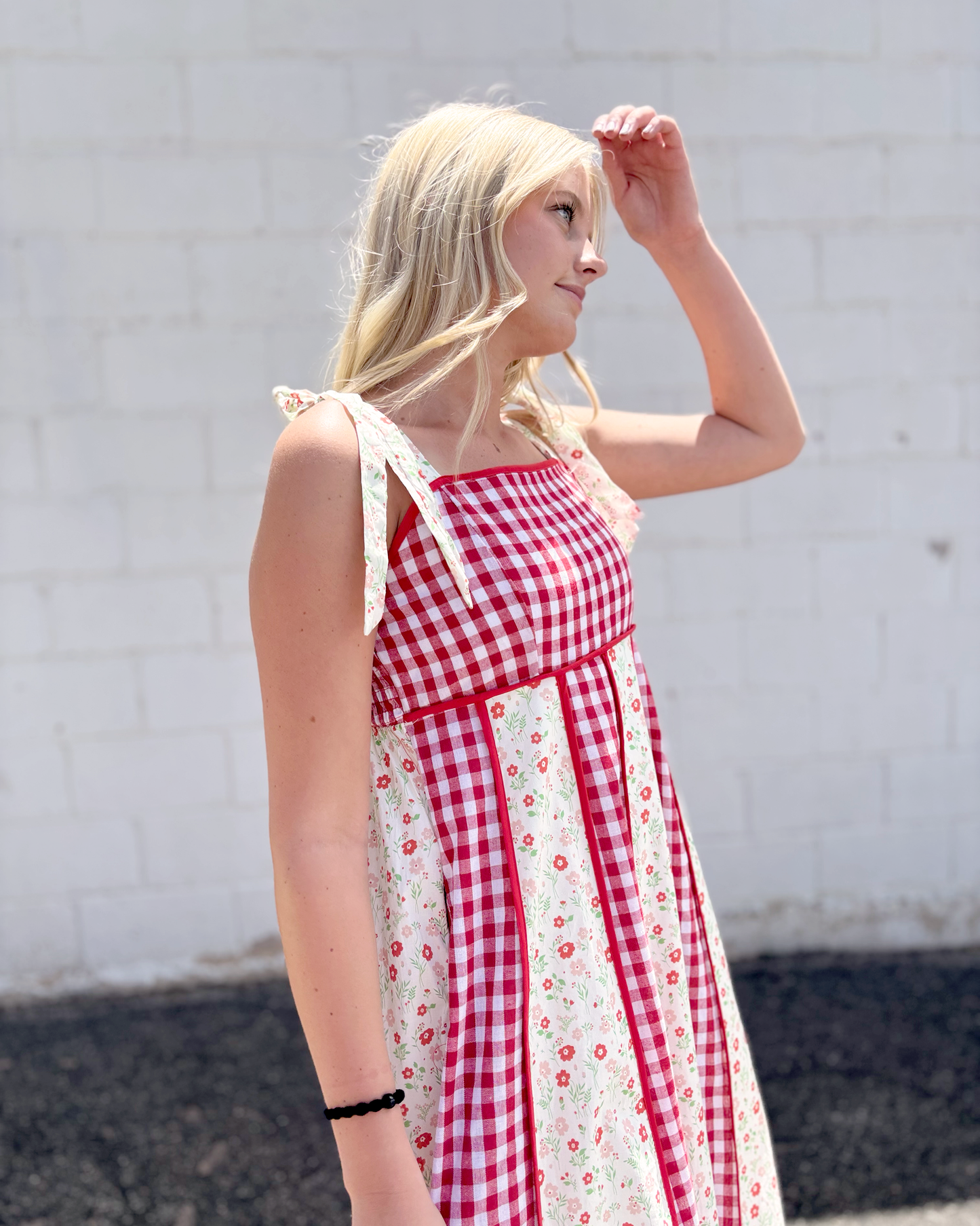 Red gingham dress with red floral print panels on a long dress with bow tie straps