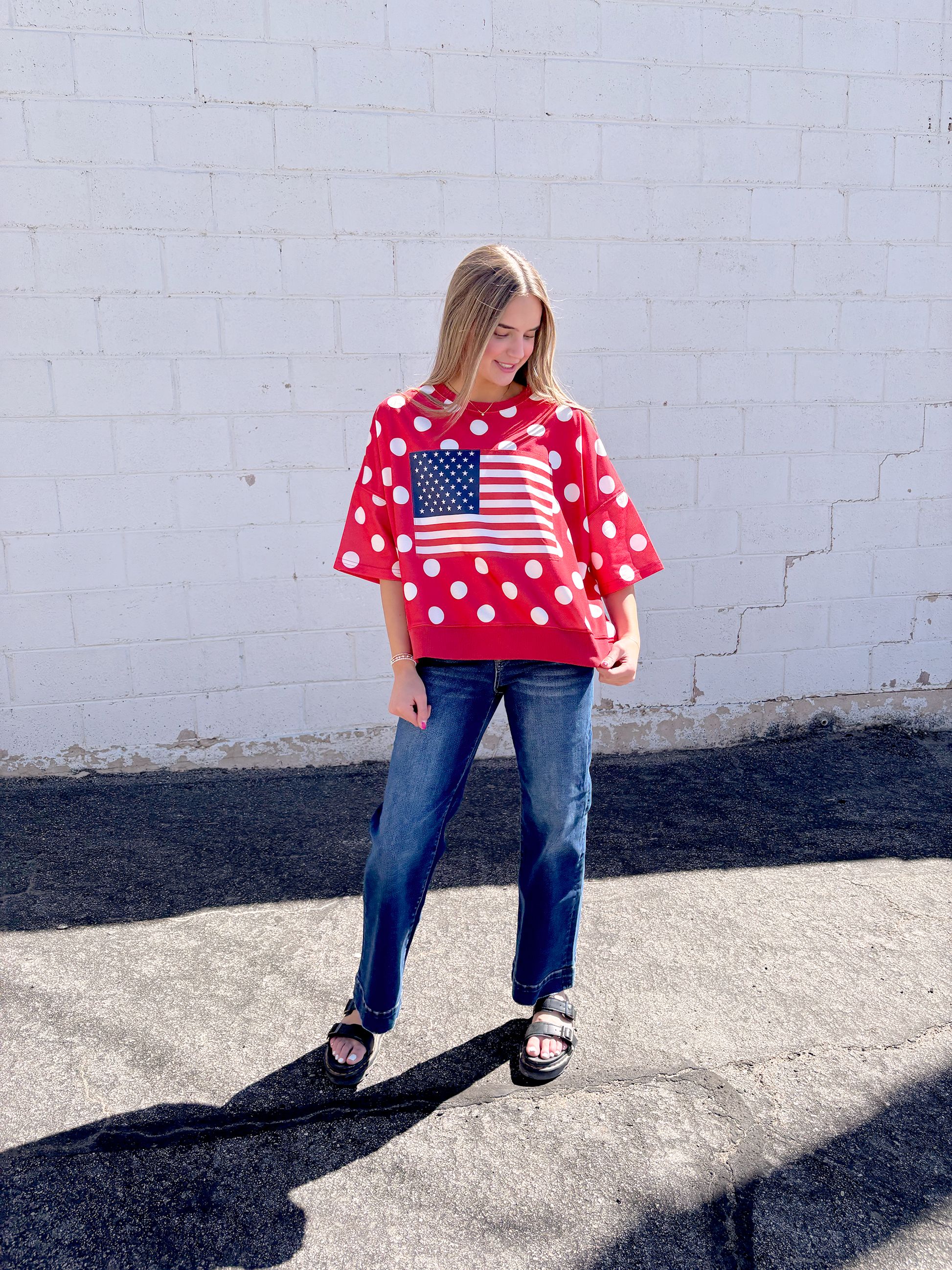 Red oversized shirt with white polka dots and a USA flag on the front