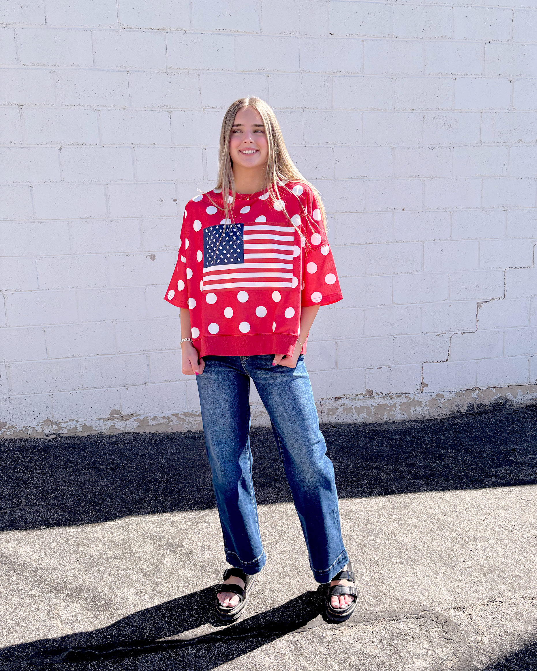 Red oversized shirt with white polka dots and a USA flag on the front