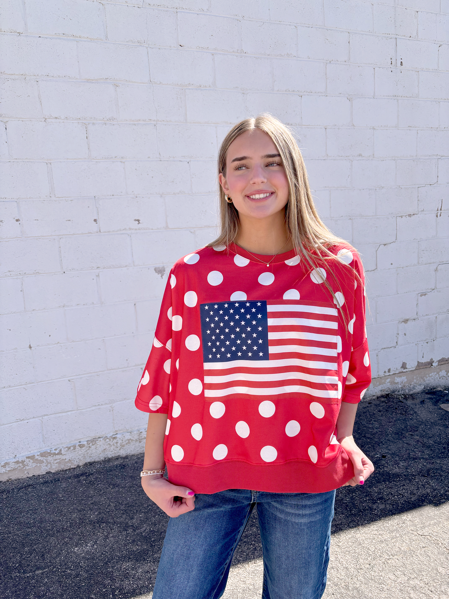 Red oversized shirt with white polka dots and a USA flag on the front