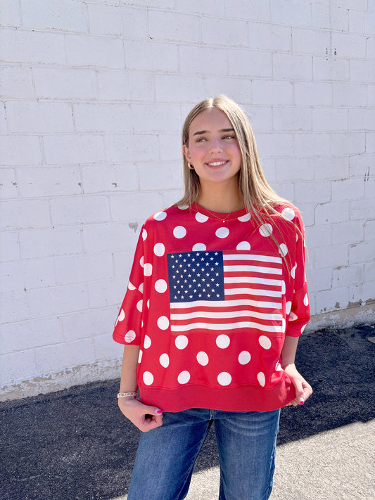 Red oversized shirt with white polka dots and a USA flag on the front