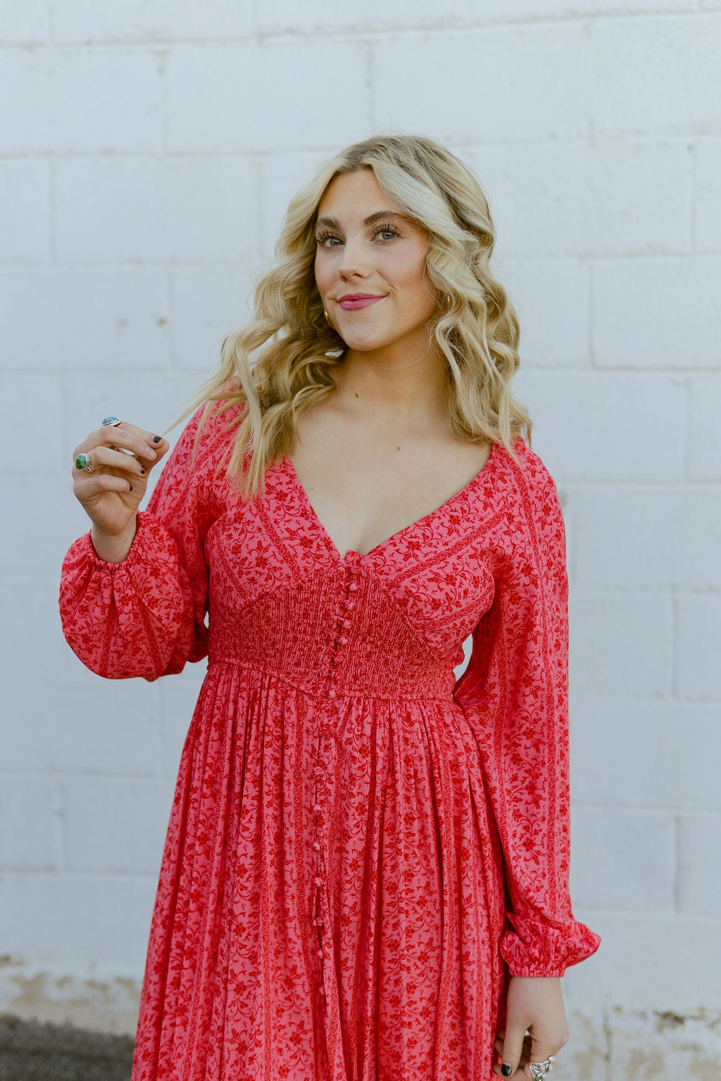 Pink dress with red floral pattern all over