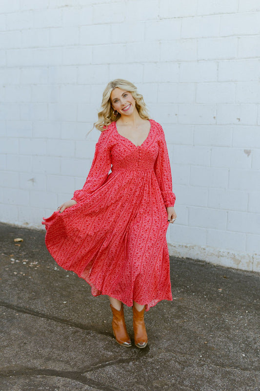 Pink dress with red floral pattern all over