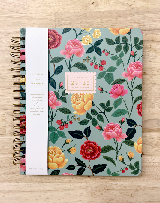 Rifle Paper Co 17-month planner with spiral binding, goals planner, sticker sheets, note pages, and a pocket folder