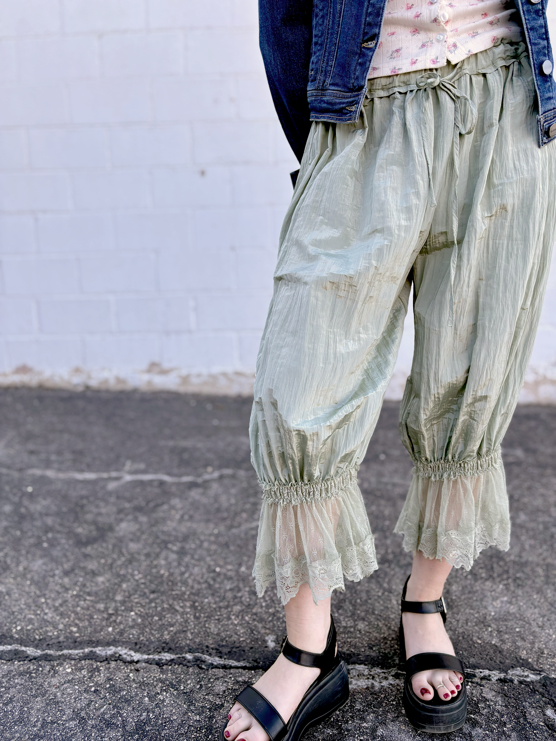 Sage colored bloomers with lace trim on the bottom