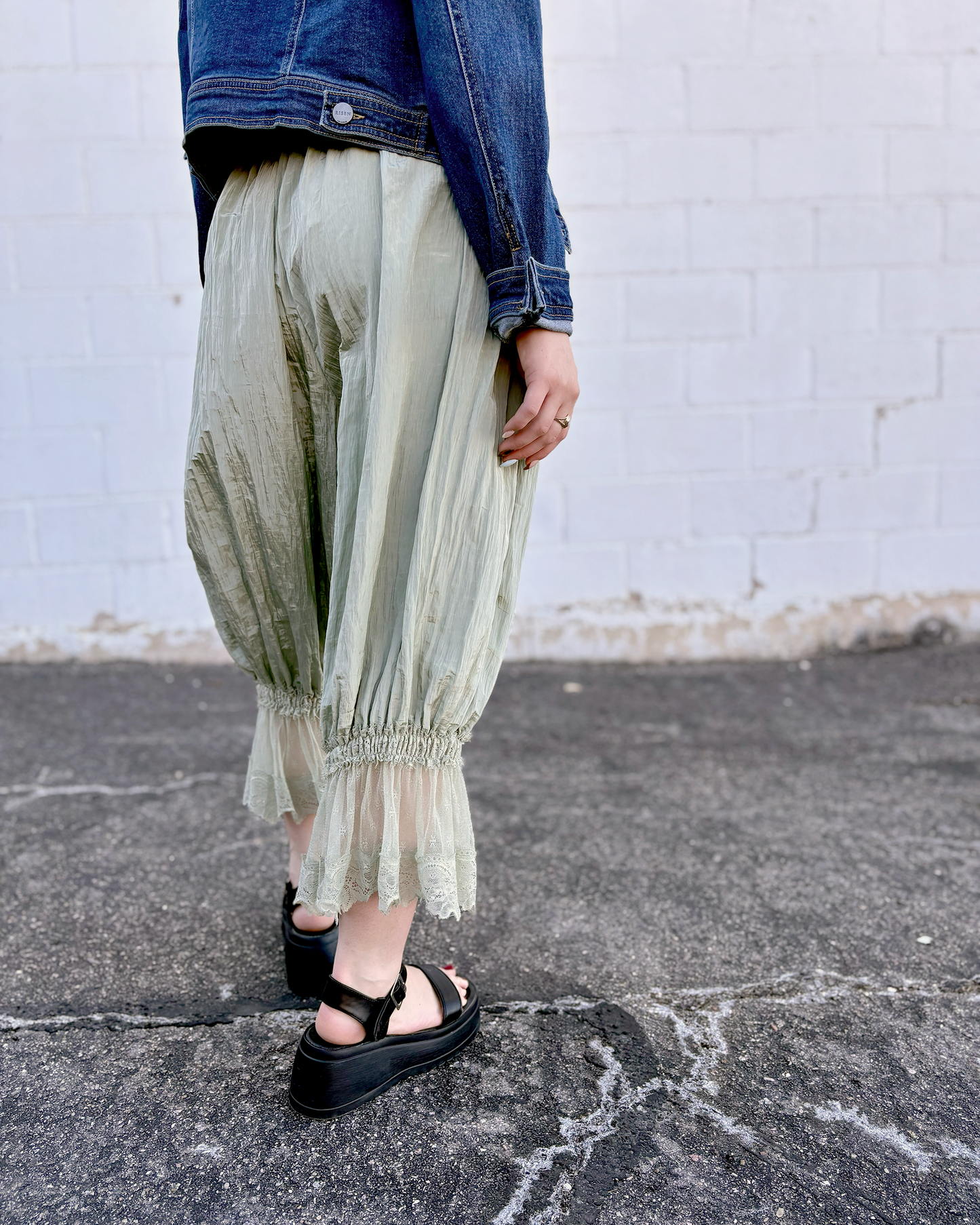 Sage colored bloomers with lace trim on the bottom