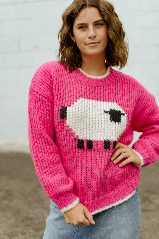 Hot pink sweater with sheep on the front