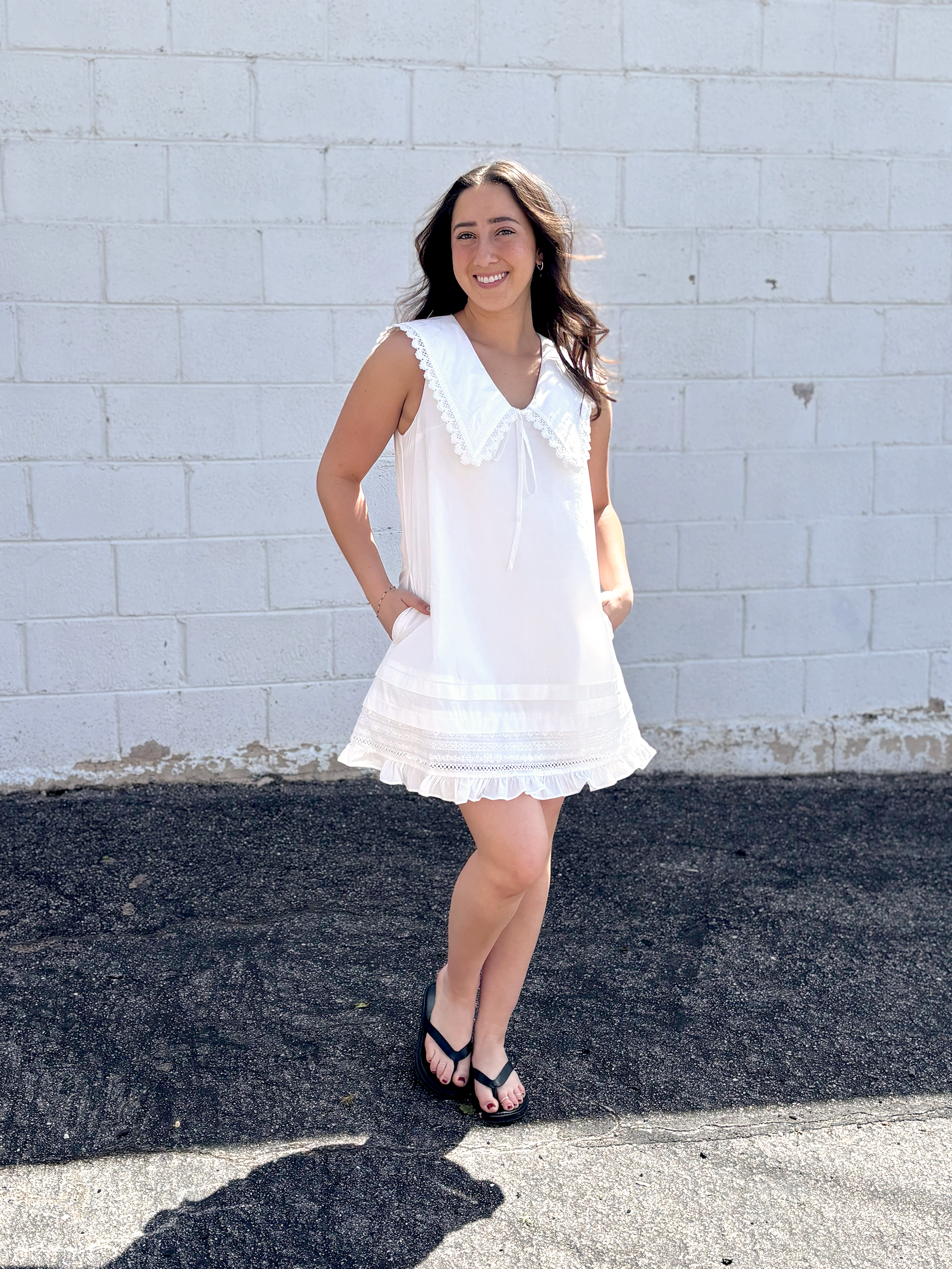 Cute white sleeveless dress with sailor's collar, short with ruffles