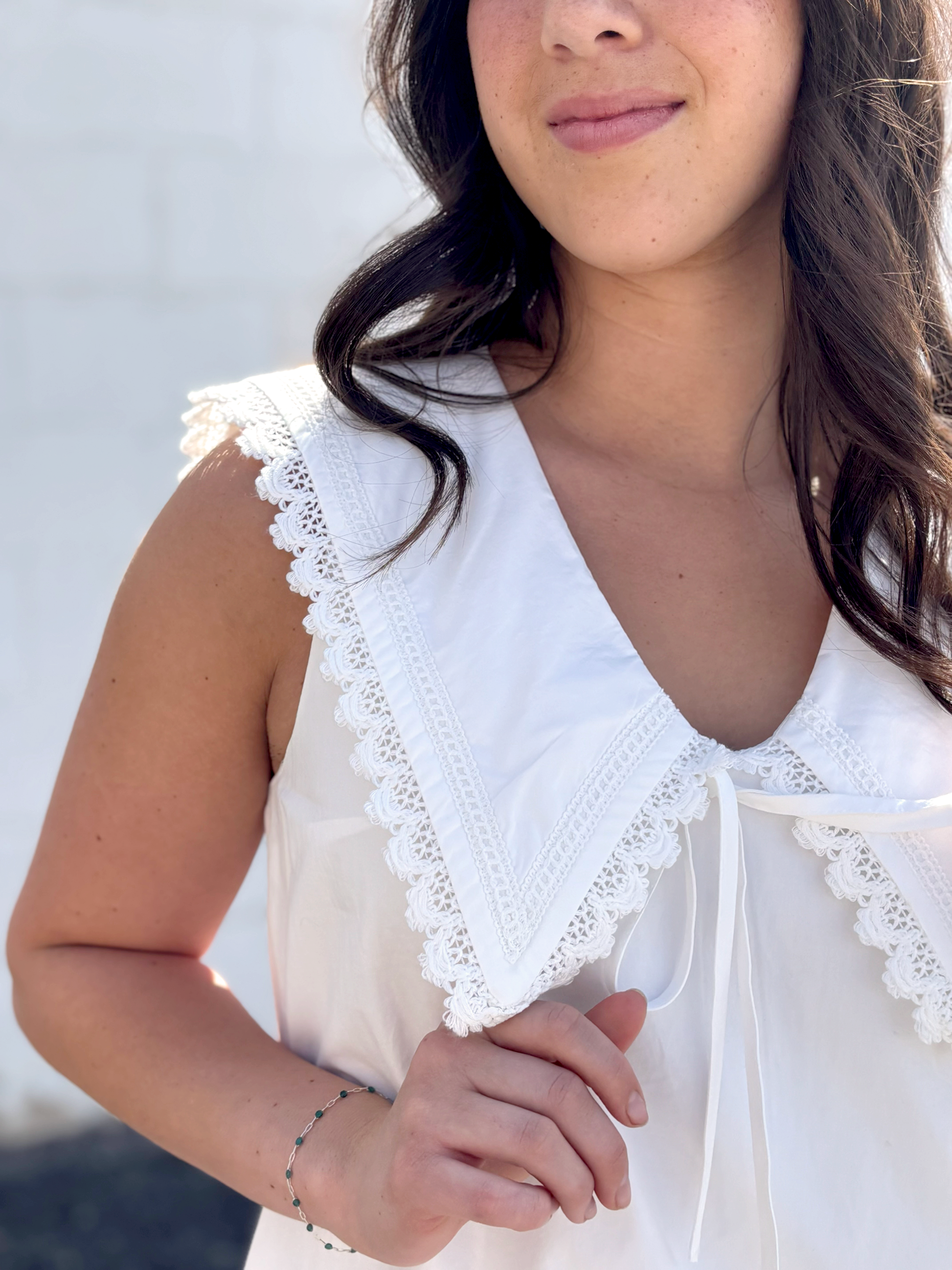 Cute white sleeveless dress with sailor's collar, short with ruffles