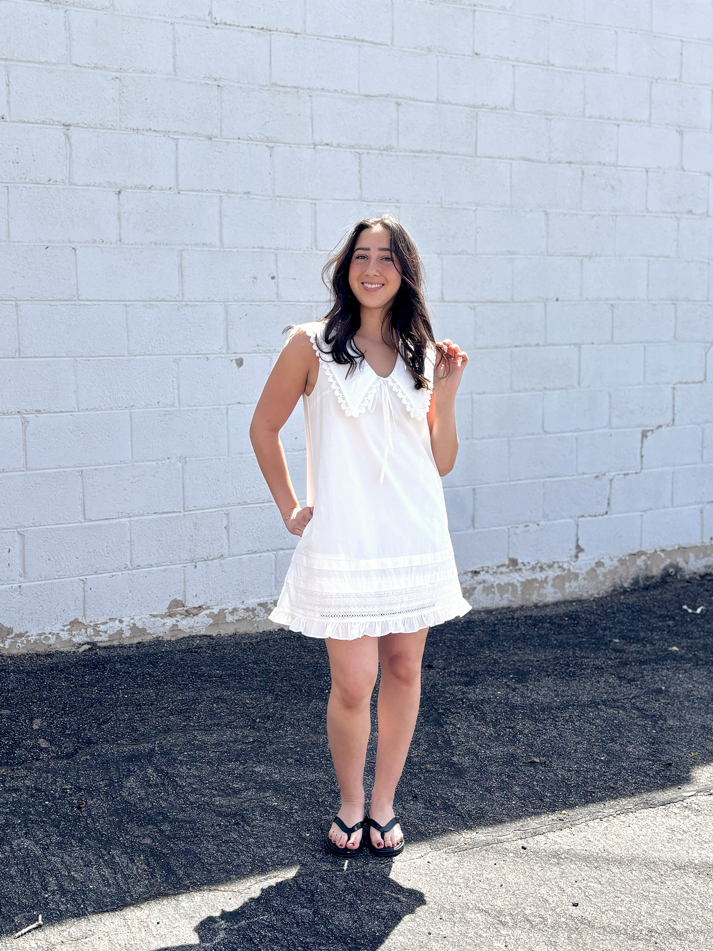 Cute white sleeveless dress with sailor's collar, short with ruffles