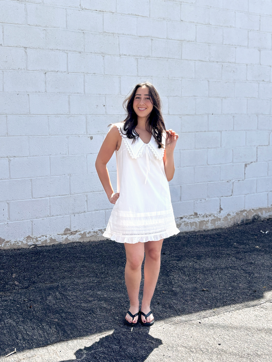 Cute white sleeveless dress with sailor's collar, short with ruffles
