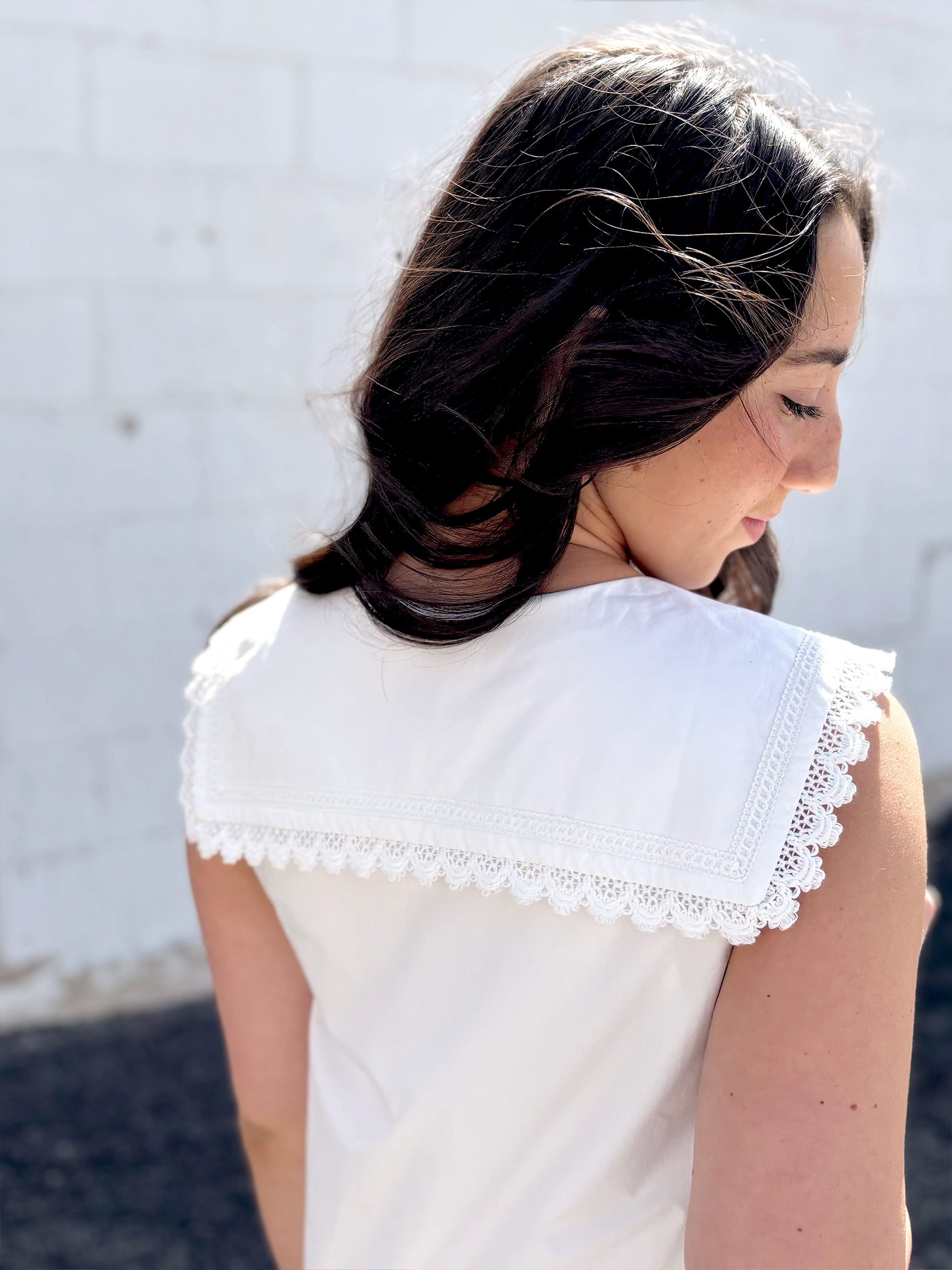 Cute white sleeveless dress with sailor's collar, short with ruffles