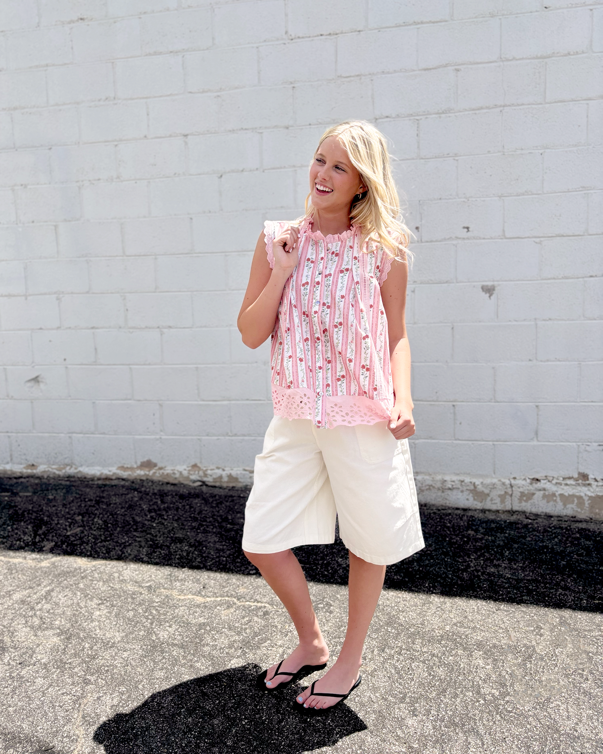 sleeveless top with pink lace trim and floral pink stripes down the front