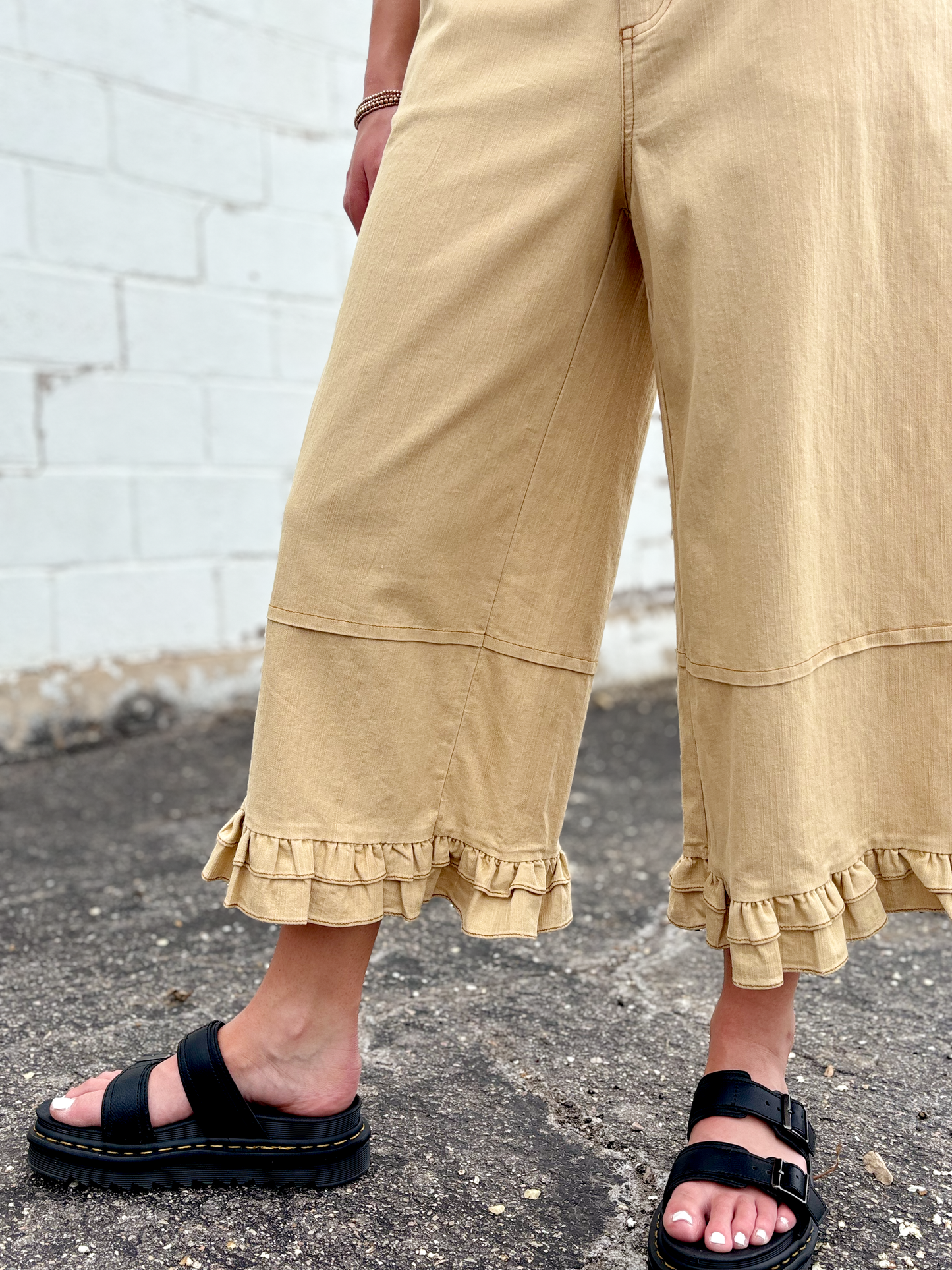 Cute wide leg tan pants with ruffles on the bottom of each leg