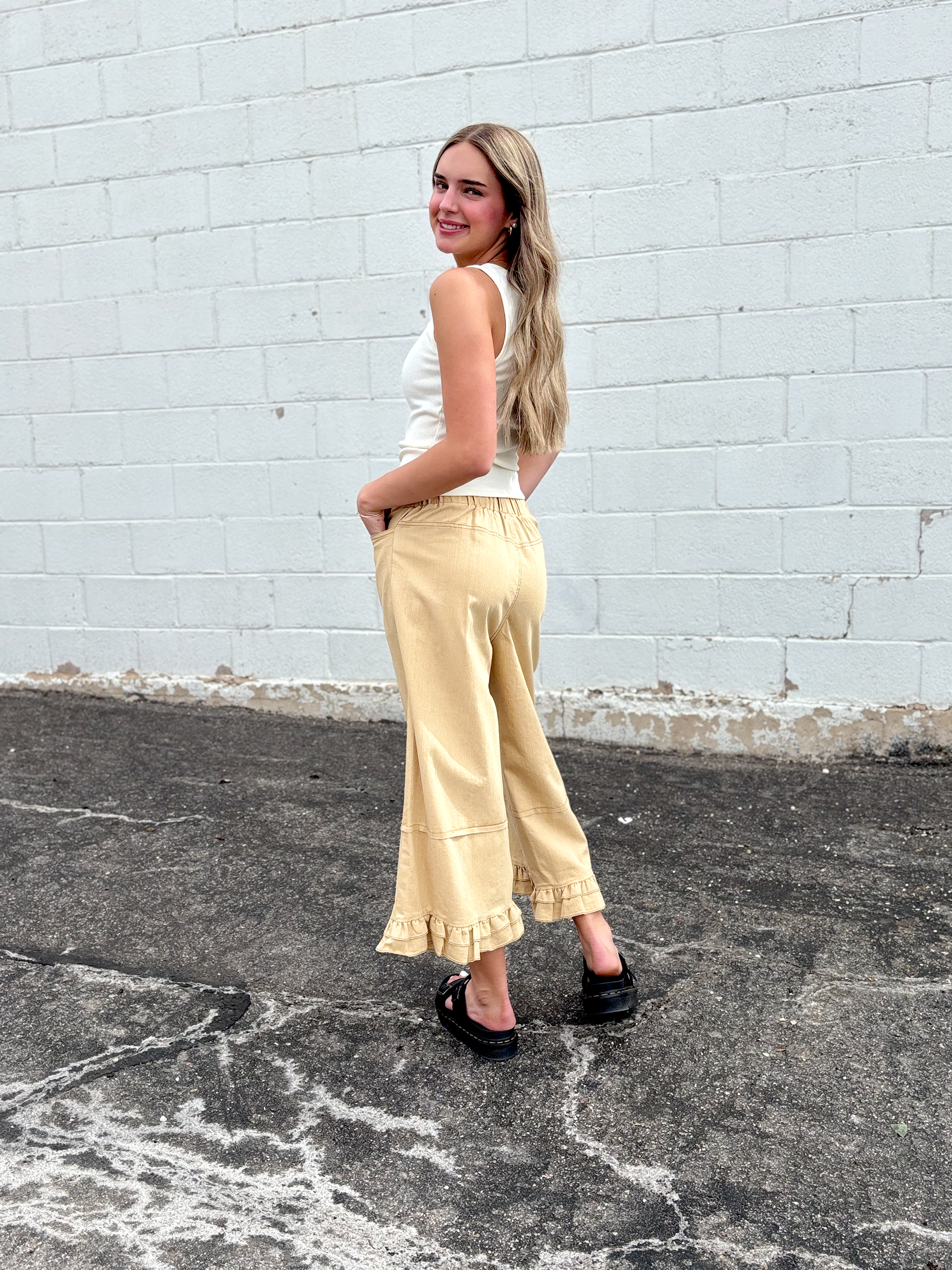 Cute wide leg tan pants with ruffles on the bottom of each leg