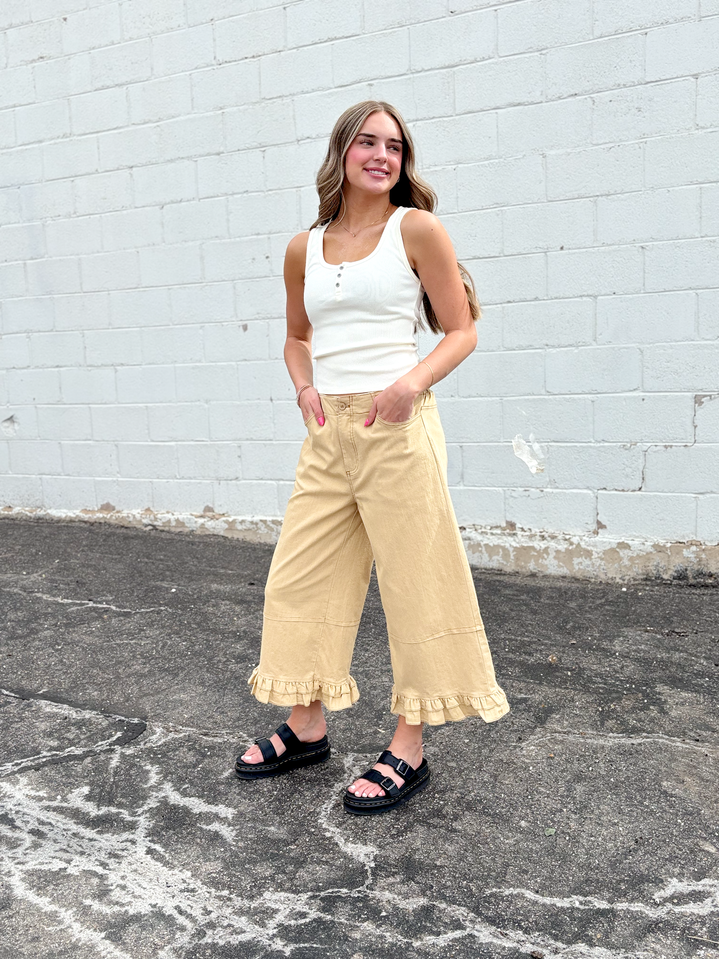 Cute wide leg tan pants with ruffles on the bottom of each leg