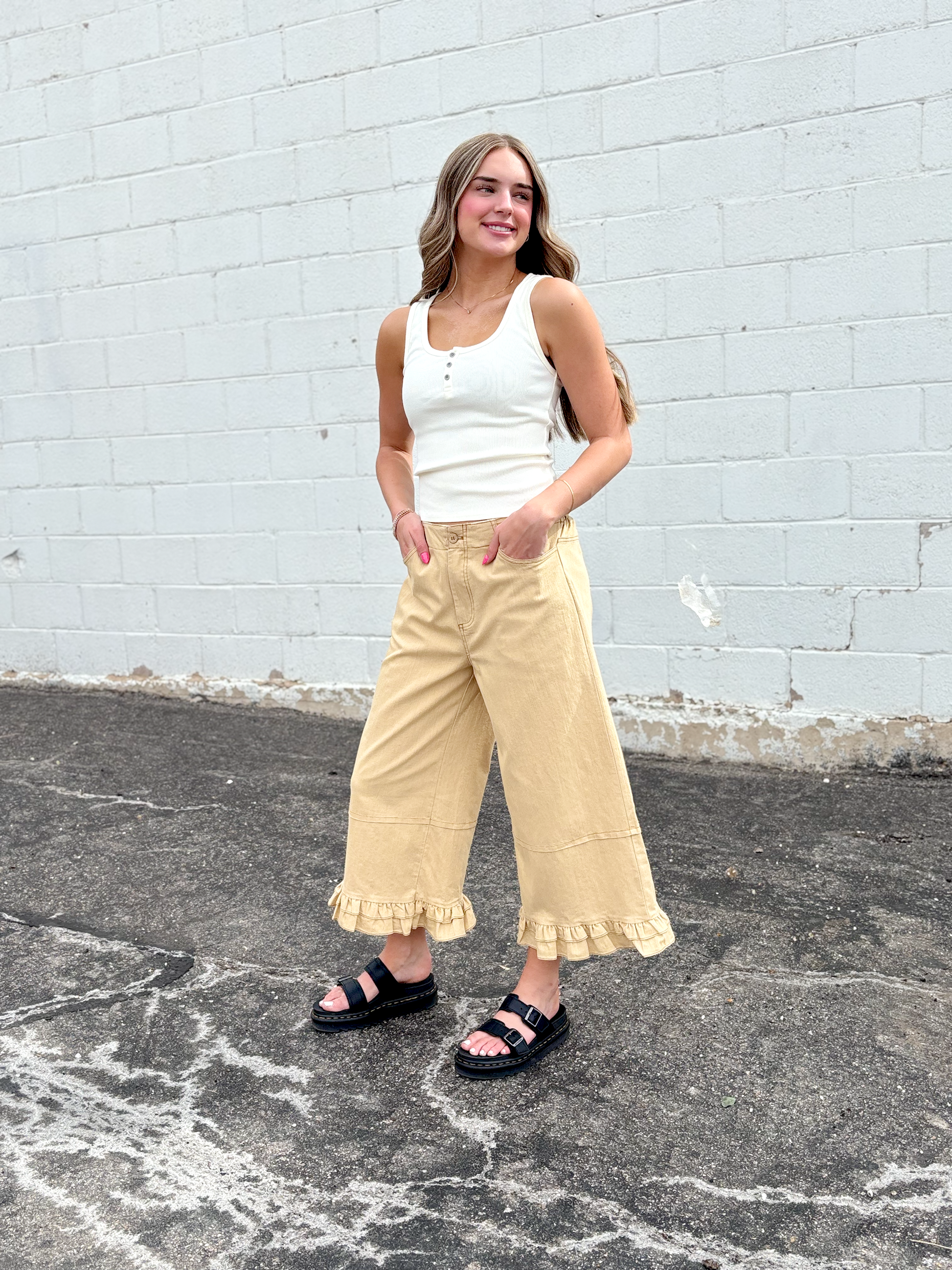 Cute wide leg tan pants with ruffles on the bottom of each leg