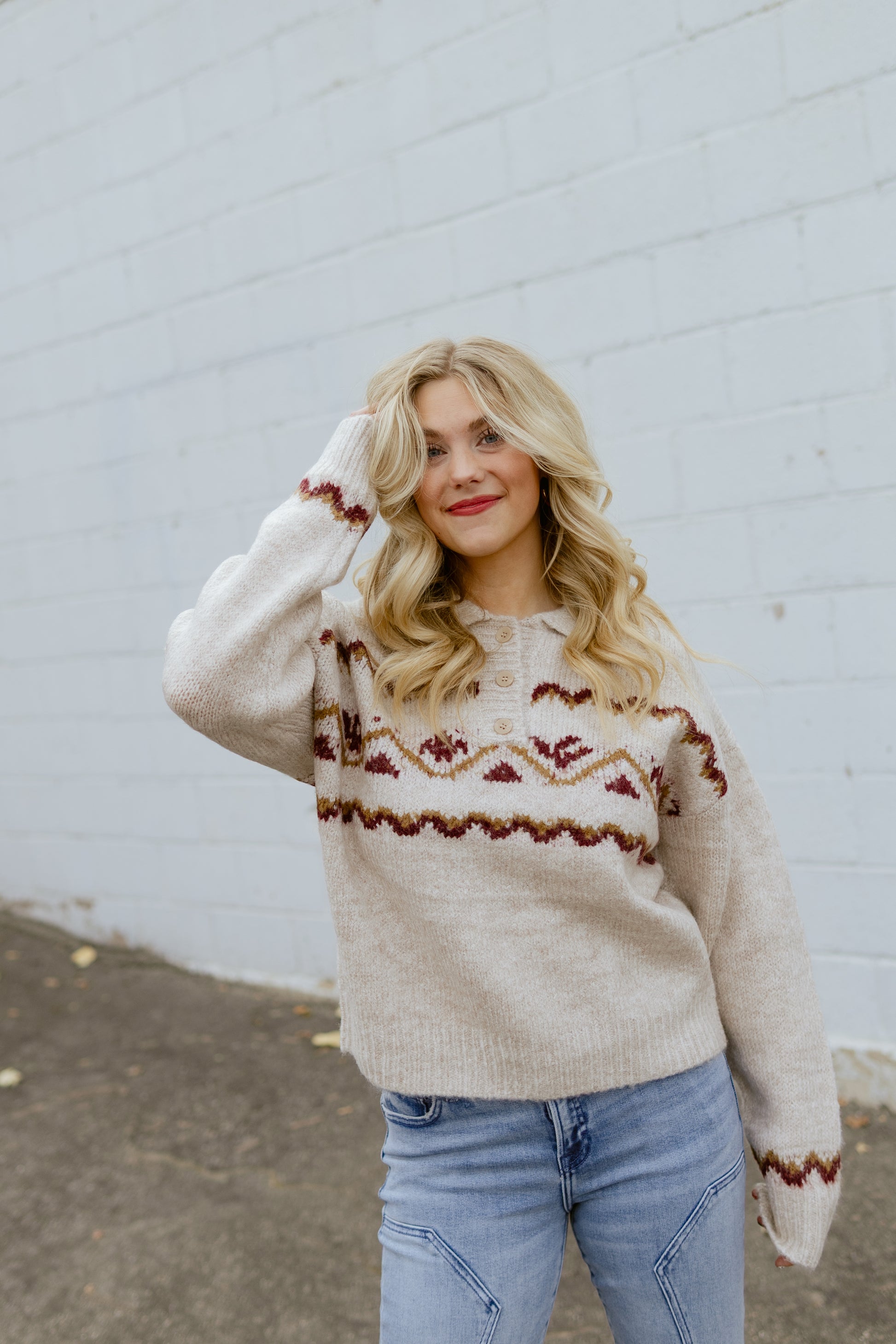 tan sweater with nordic print across the front and three buttons