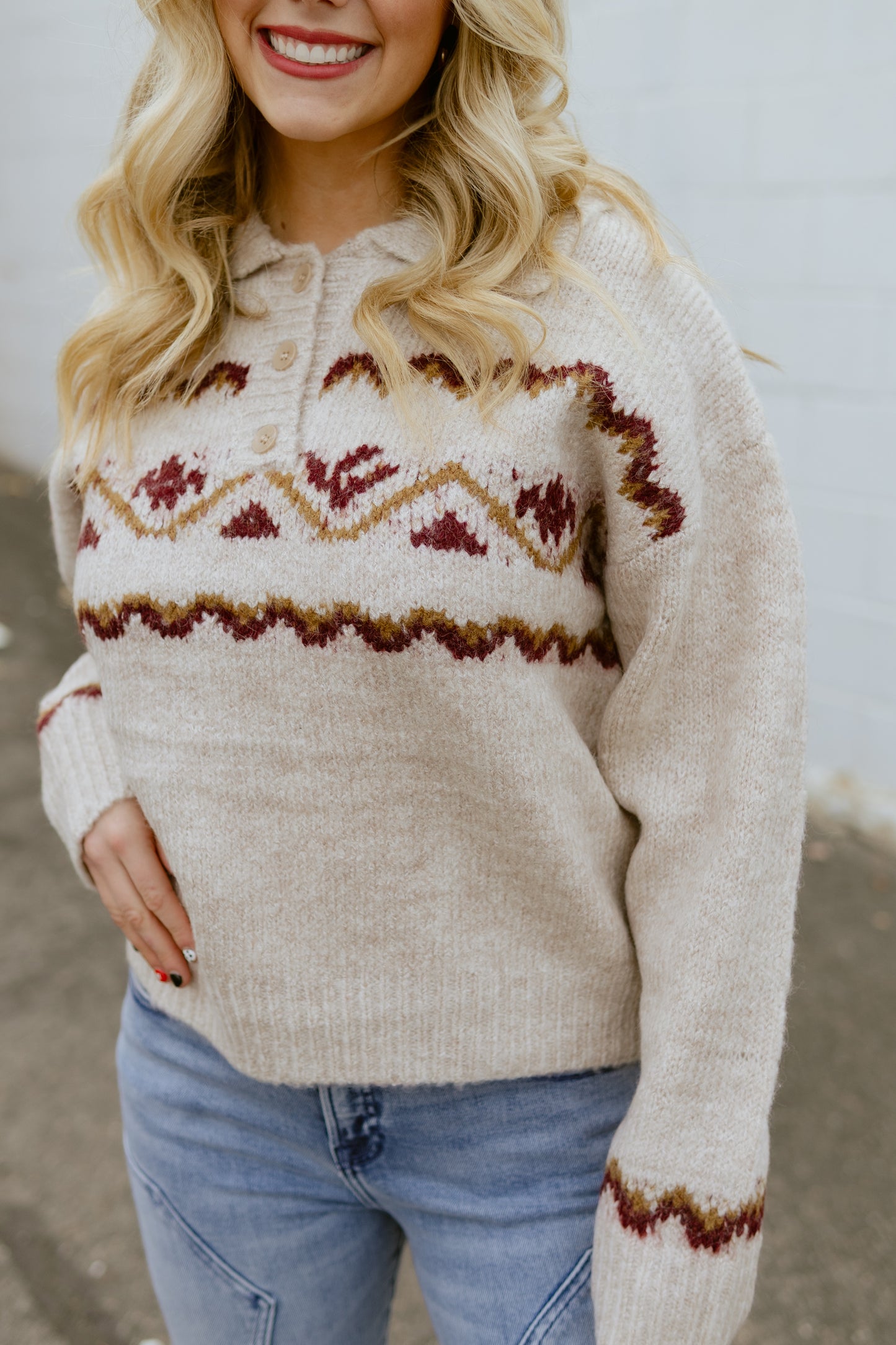 tan sweater with nordic print across the front and three buttons