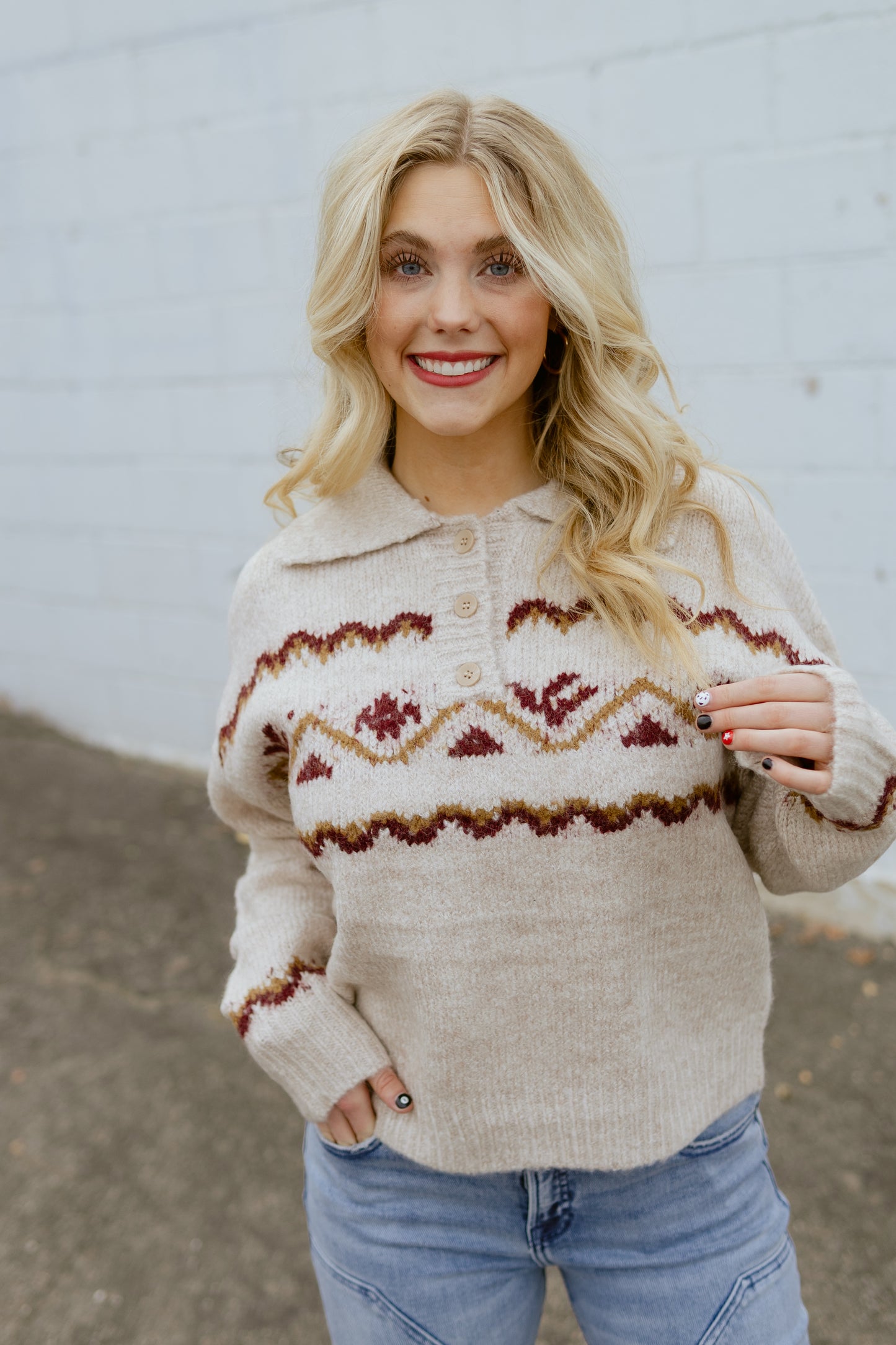 tan sweater with nordic print across the front and three buttons