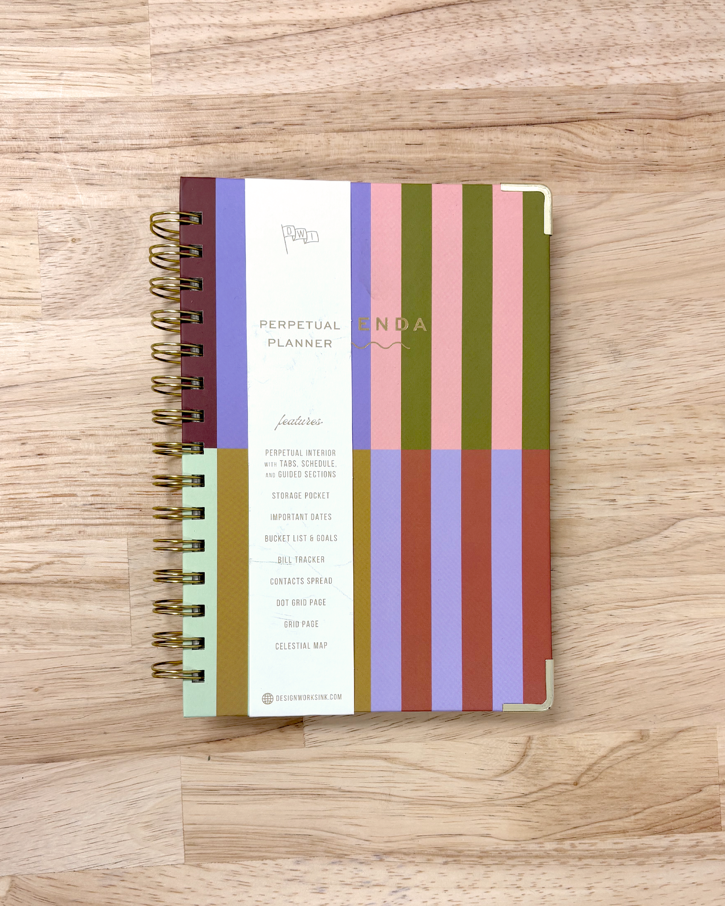 Perpetual planner with colorful striped design on a wooden surface