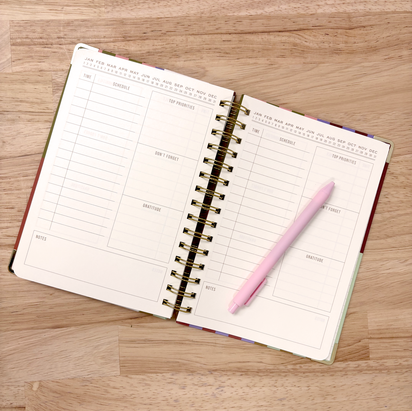 Perpetual planner with colorful striped design on a wooden surface