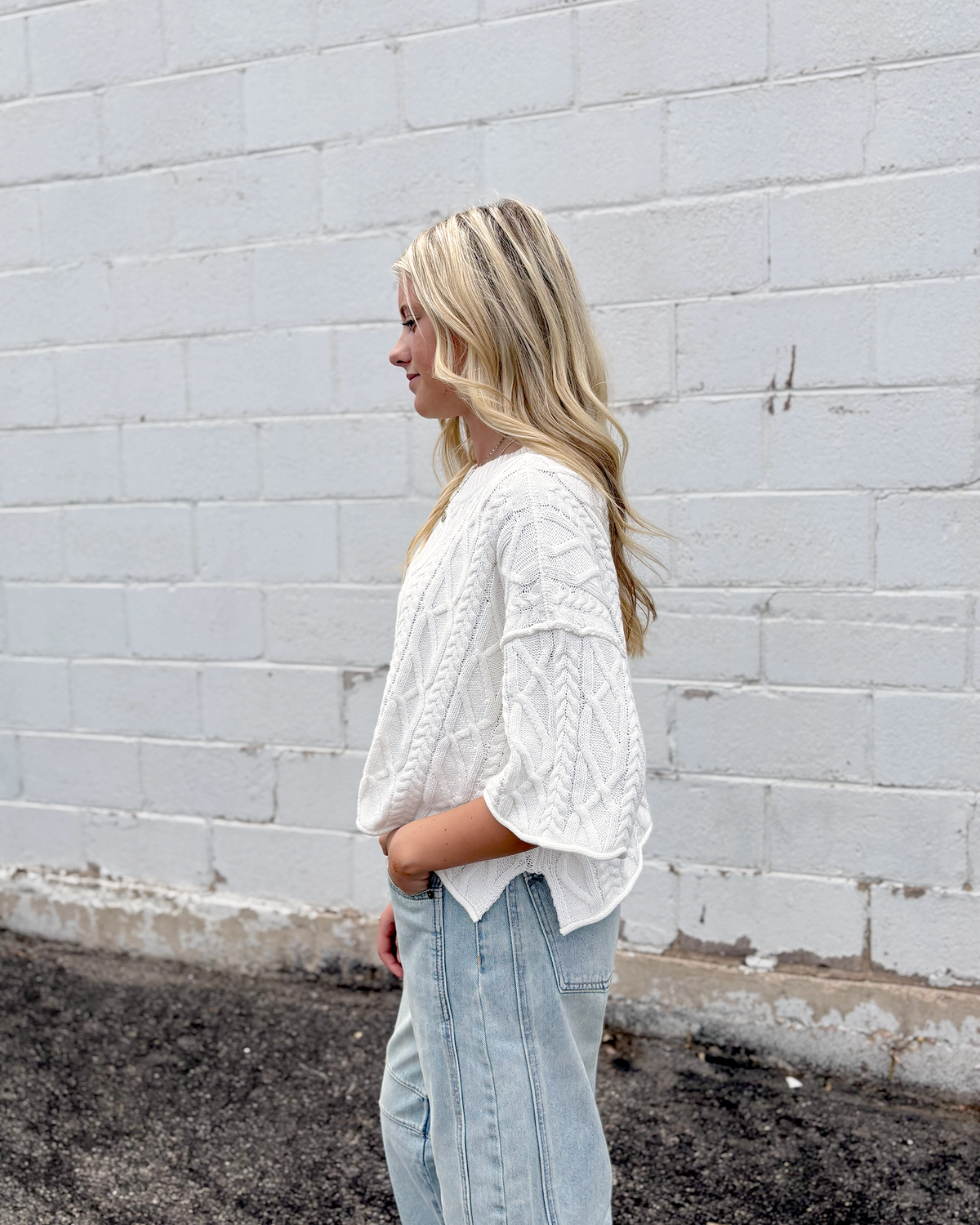 Cute white cropped sweater with short sleeves in a cable knit pattern