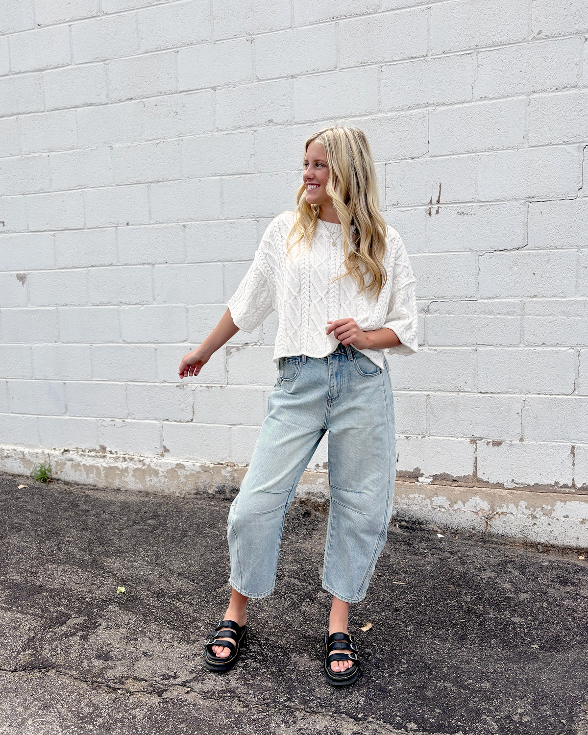 Cute white cropped sweater with short sleeves in a cable knit pattern
