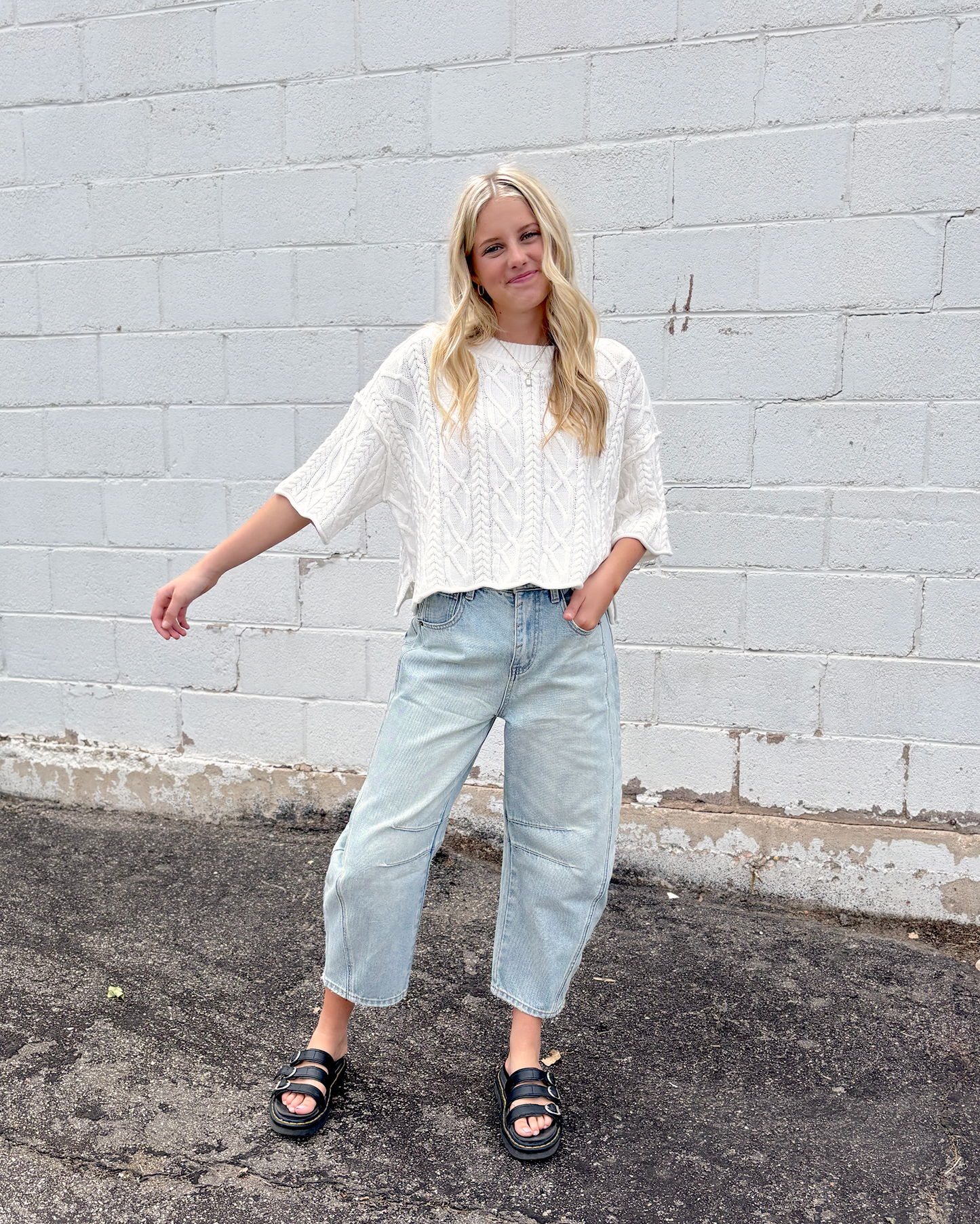 Cute white cropped sweater with short sleeves in a cable knit pattern