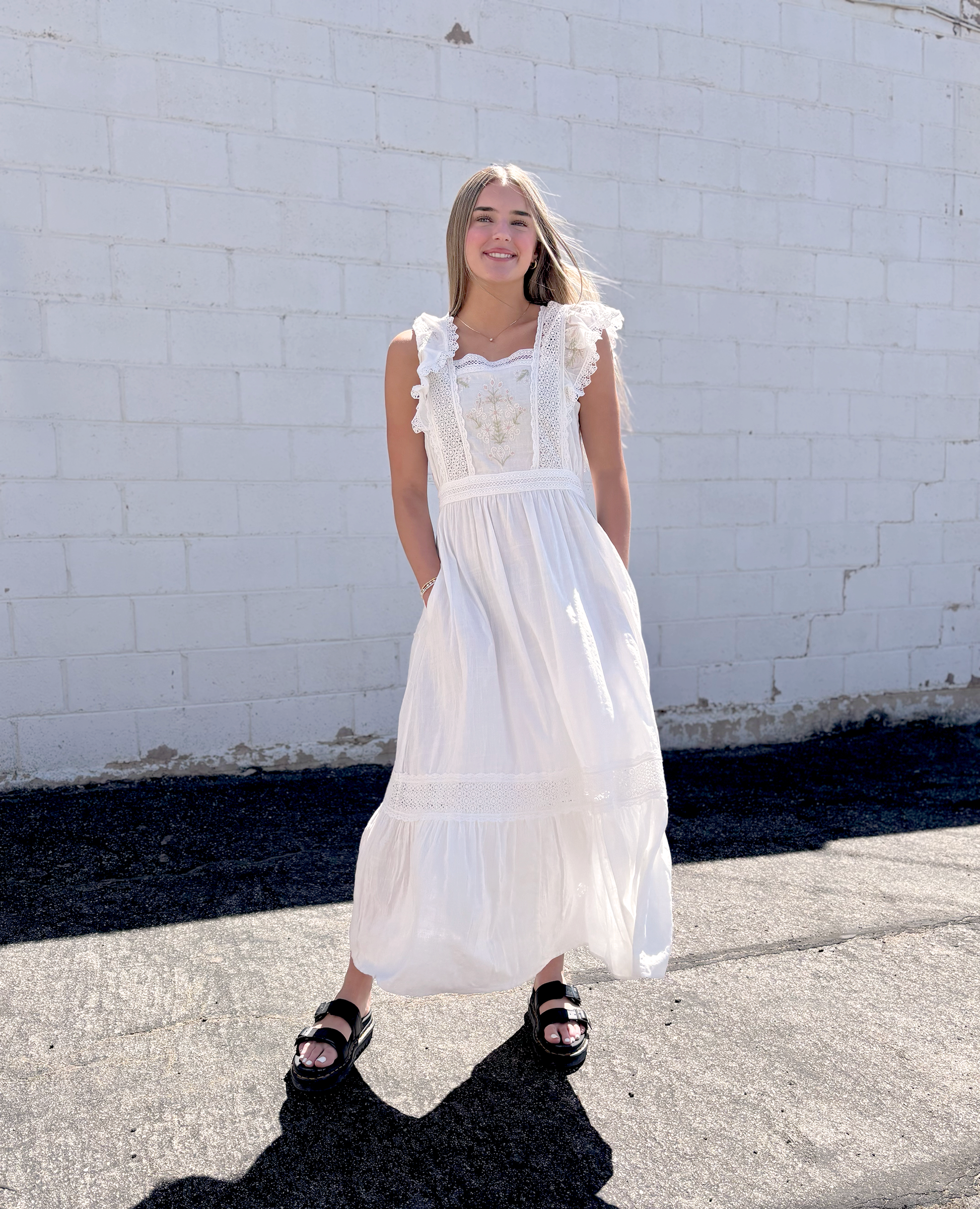 White dress with flutter sleeves and embroidered details