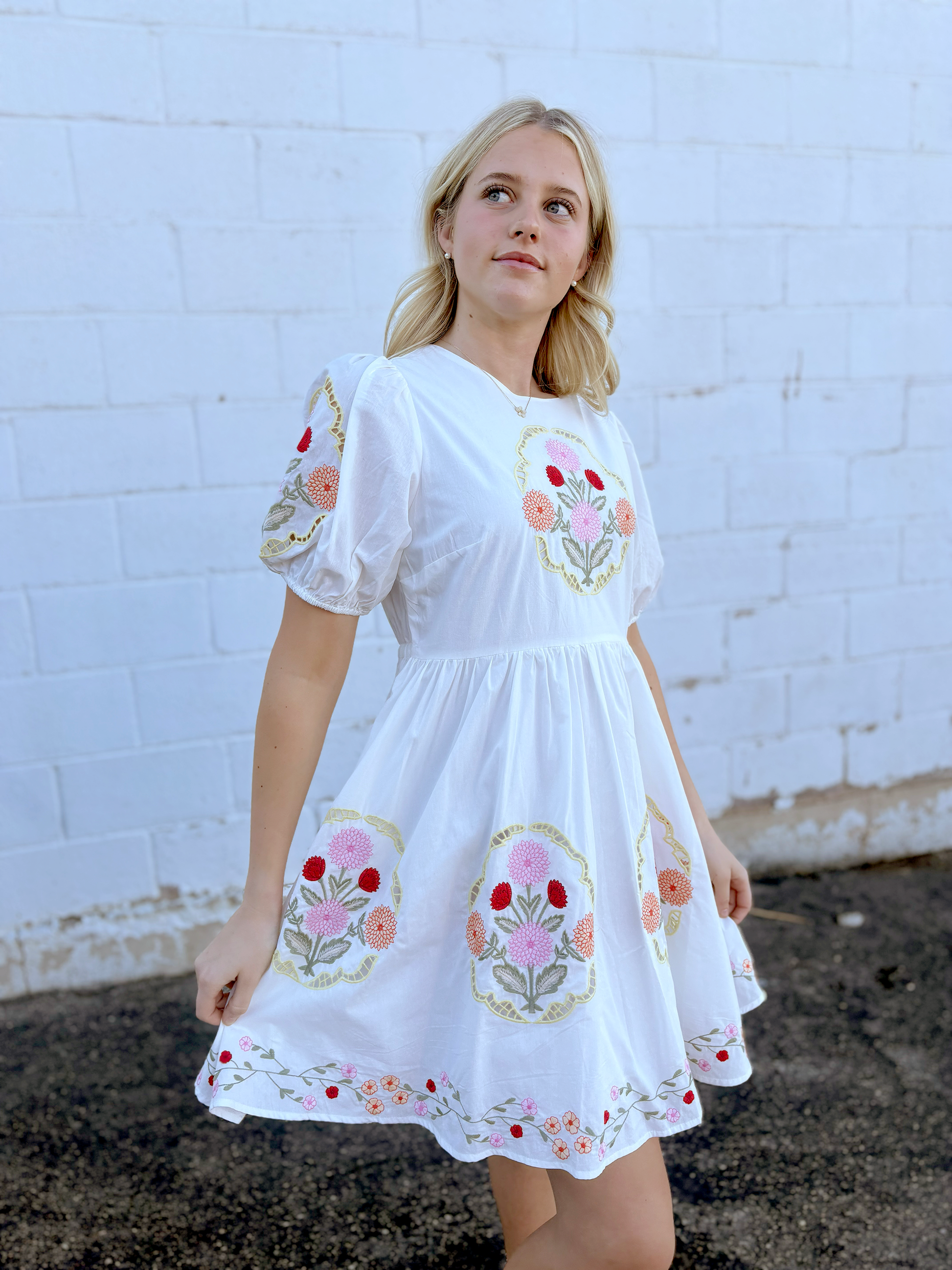 White dress with floral embroidery details