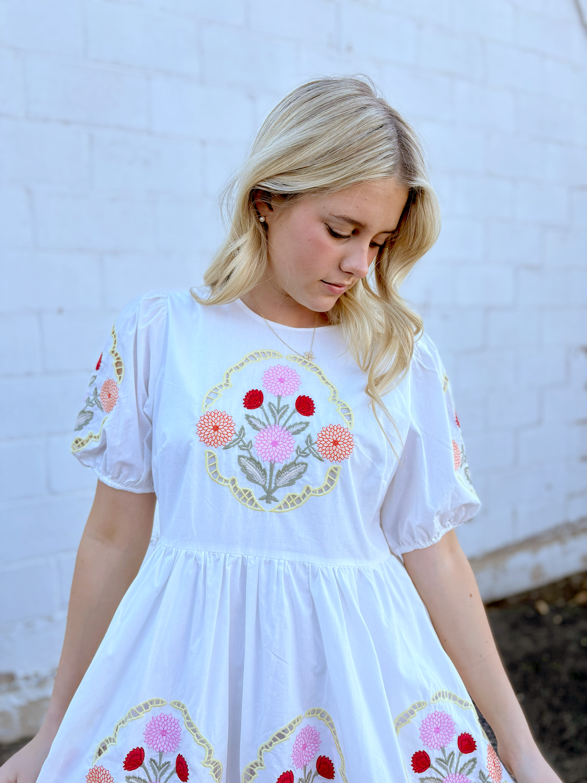 White dress with floral embroidery details
