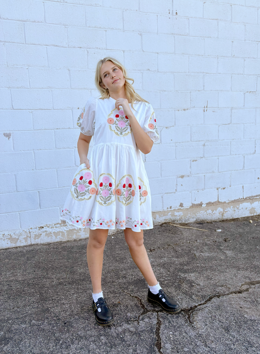 White dress with floral embroidery details
