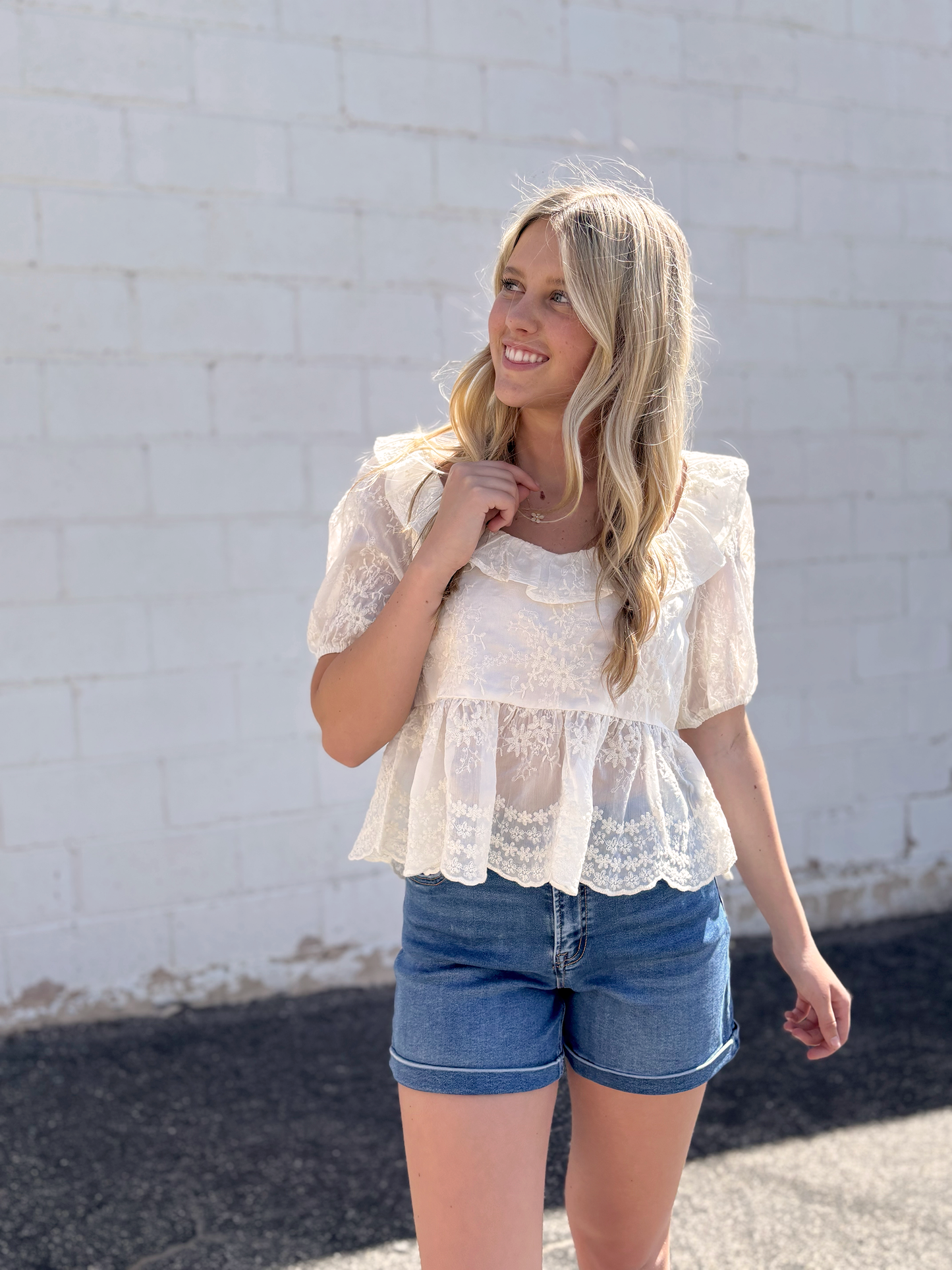 Pretty top with empire waist and scoop neck with floral embroidery and puff sleeves
