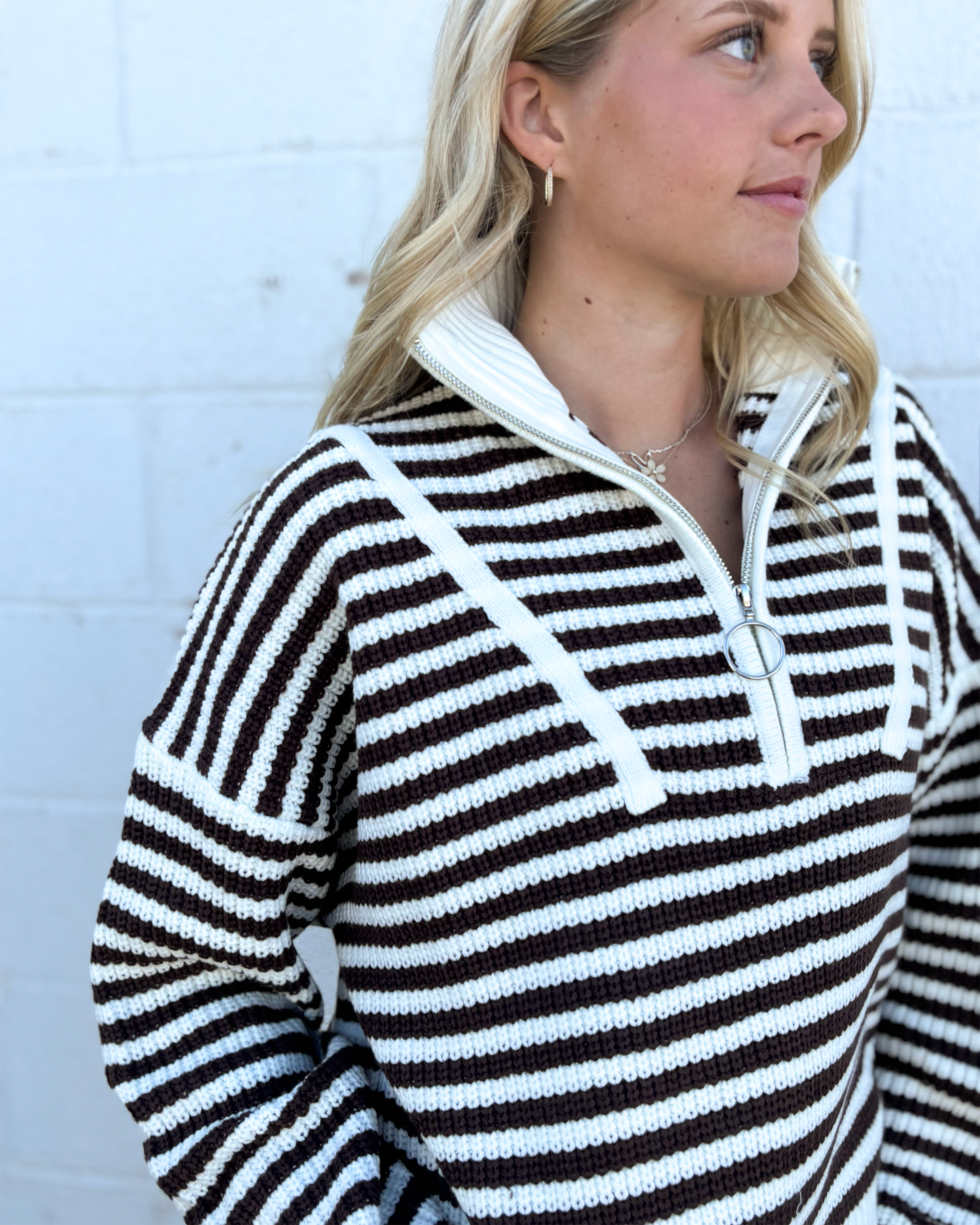 Sweater with mocha colored stripes and a half zip collar