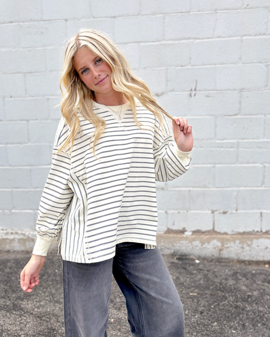 White oversized sweater with black stripes
