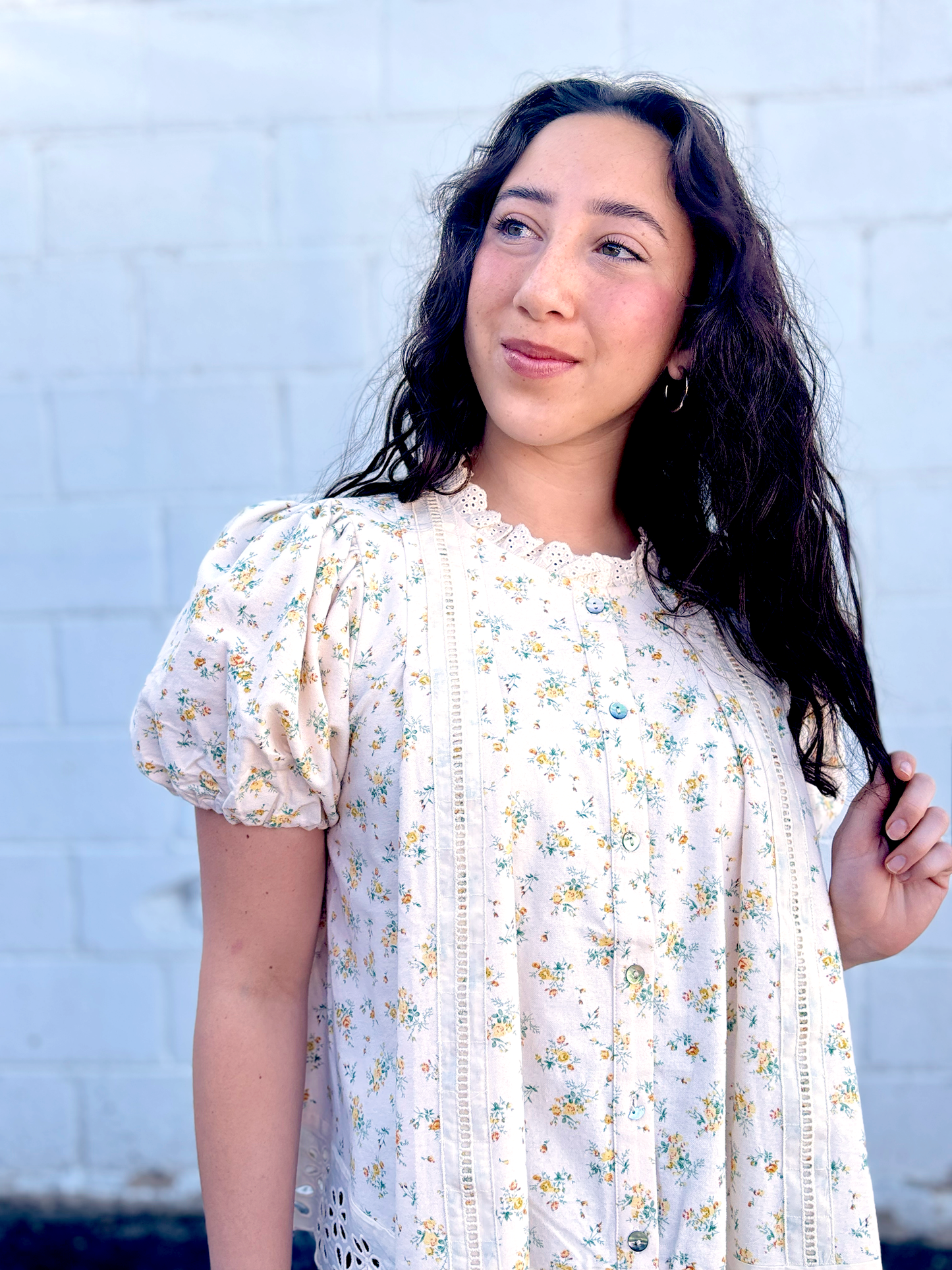 Yellow flowered top with large lace trim along the bottom