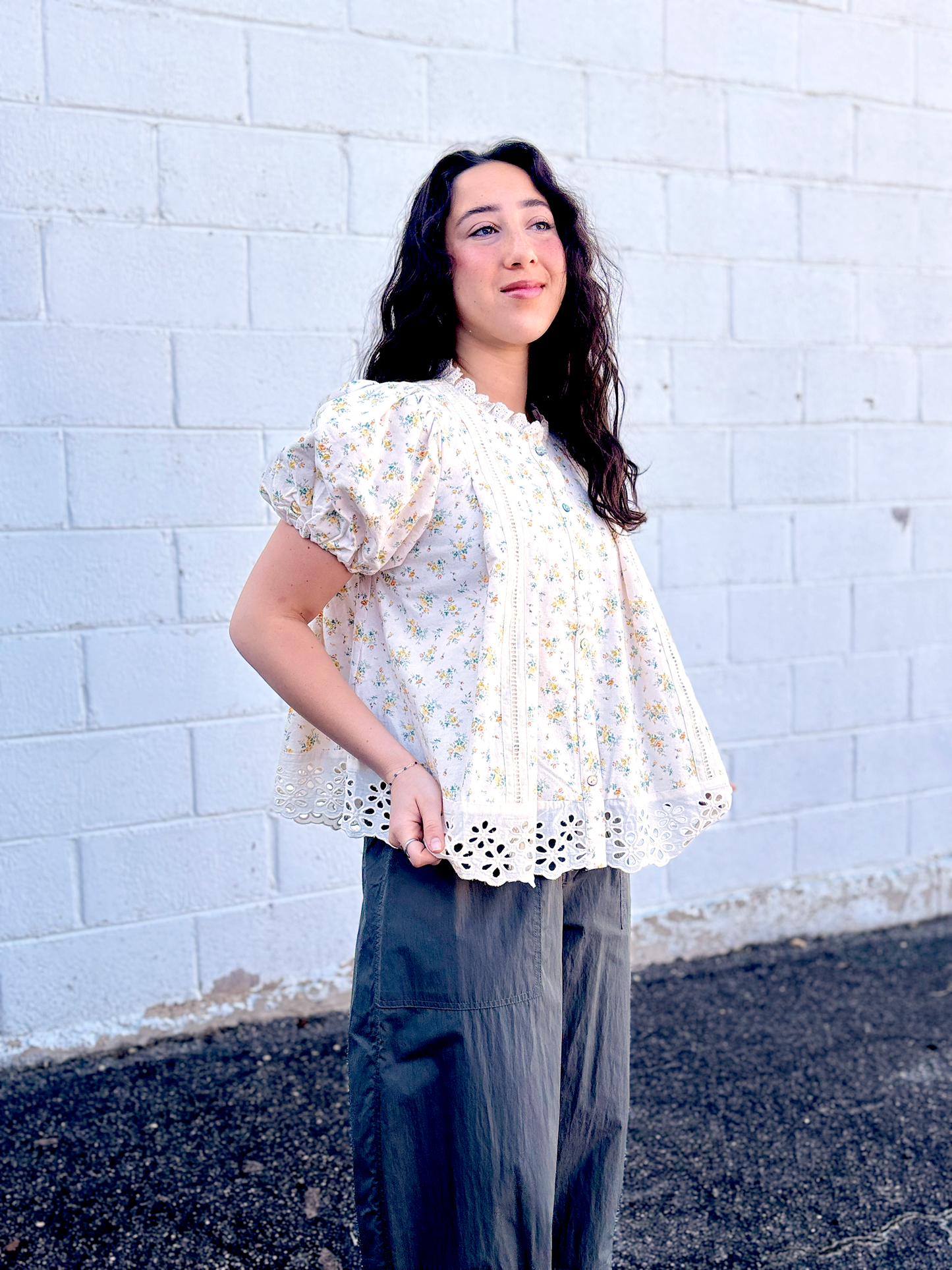 Yellow flowered top with large lace trim along the bottom