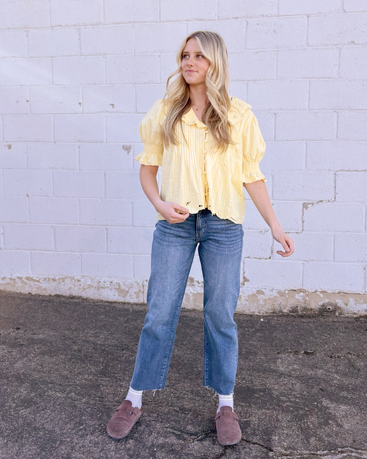 Yellow top with puff sleeves and embroidered embellishments