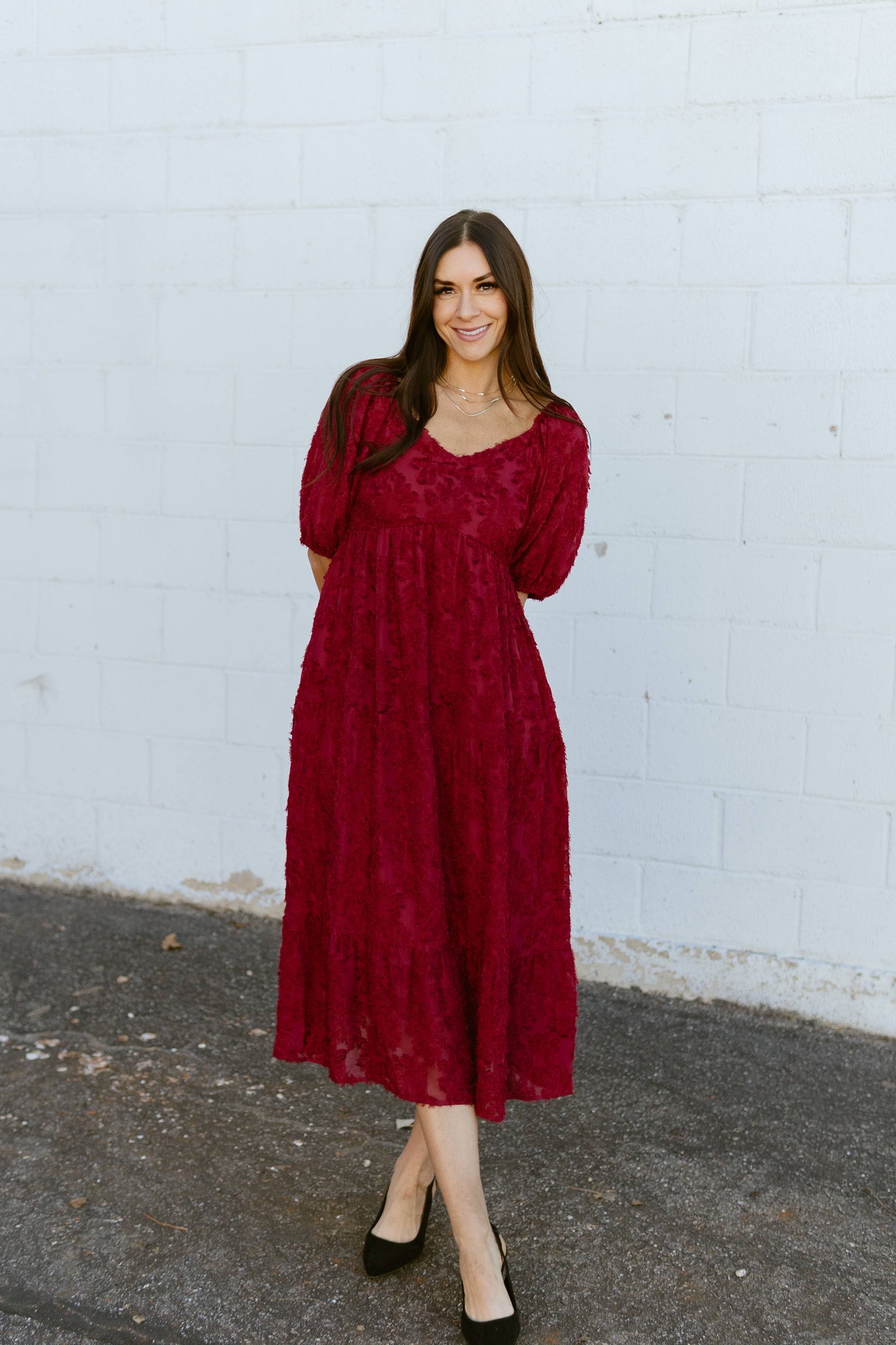 red dress with textured lace over top