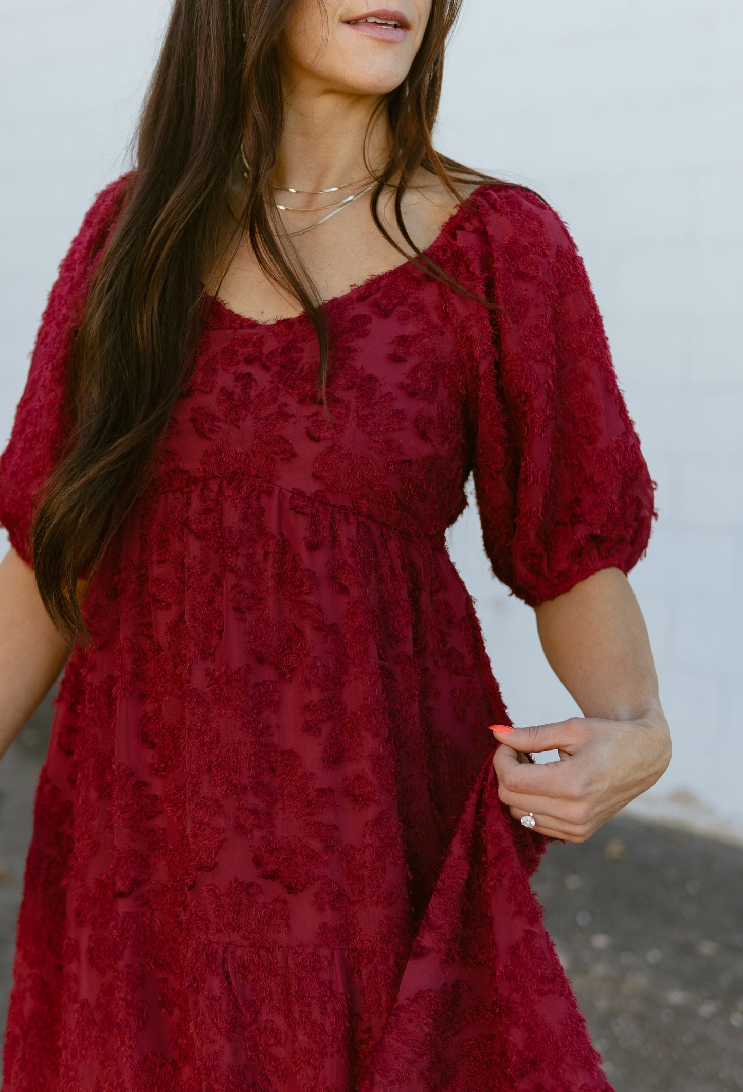 red dress with textured lace over top