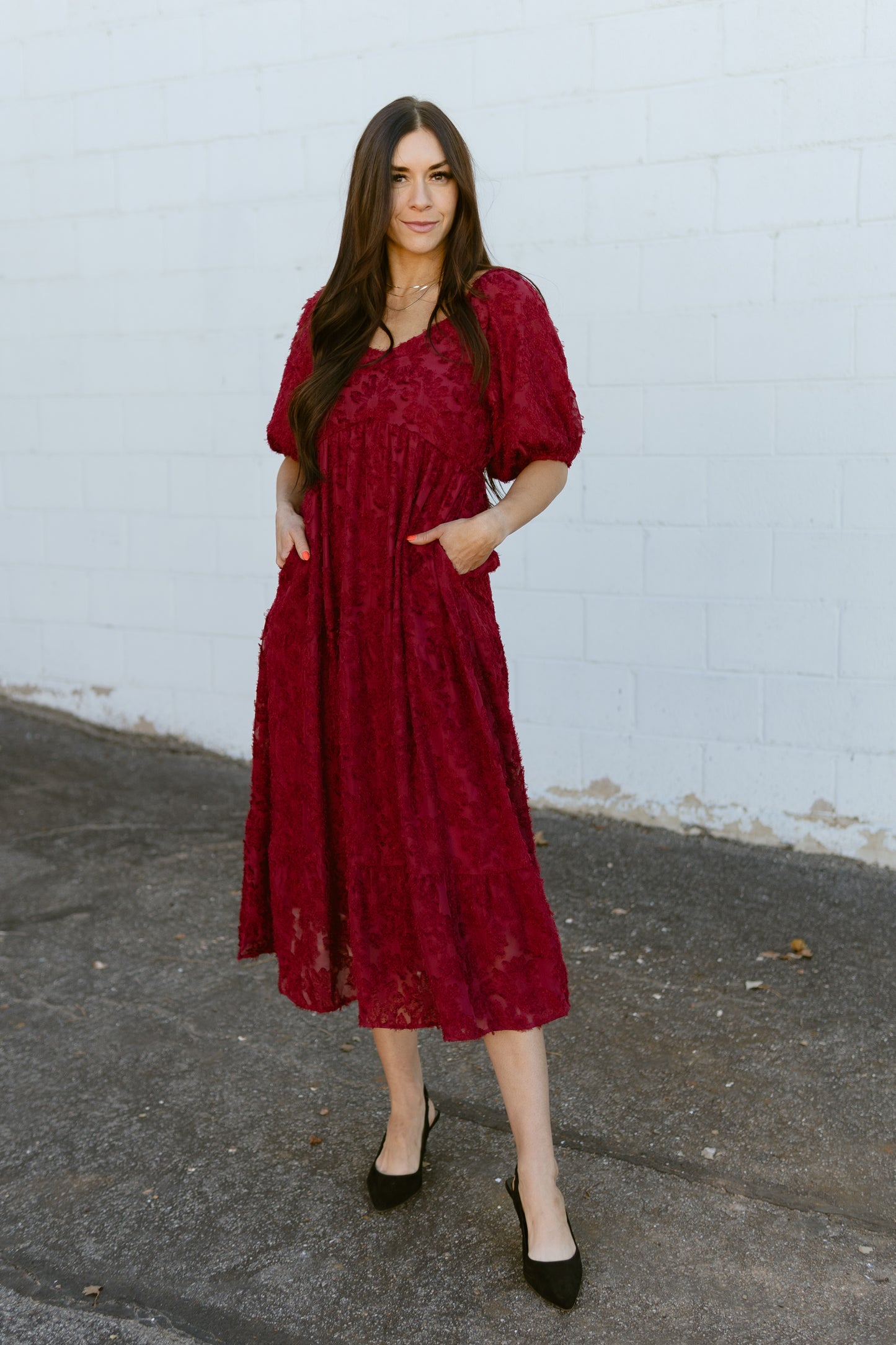 red dress with textured lace over top