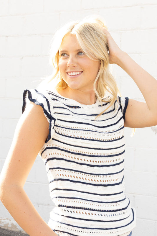 white sleeveless sweater with navy stripes